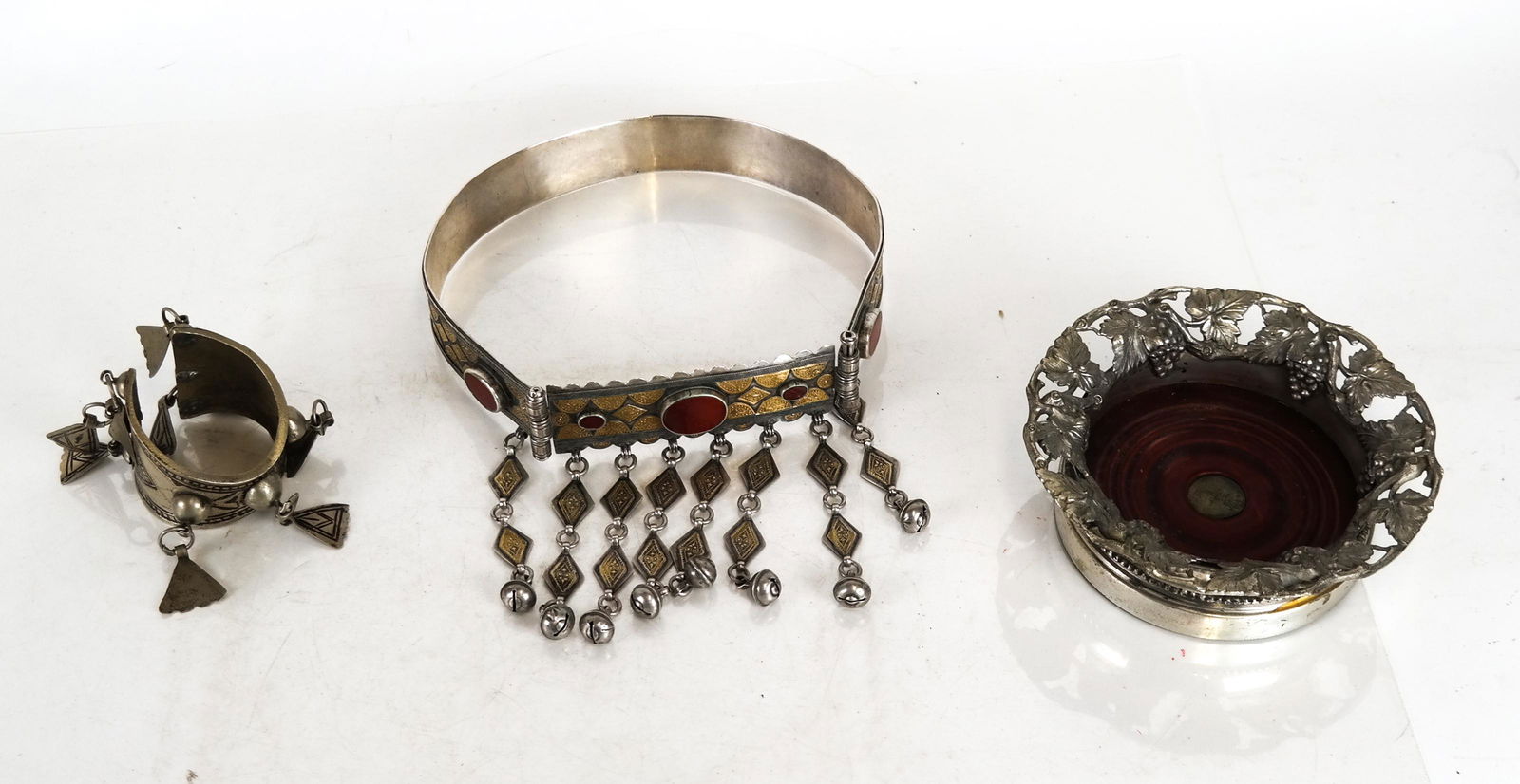 Ethnographic Silver Jewelry and Wine Coaster: Ethnographic silver cuff and belt with carnelian stones; a wine coaster, and a belt [approx. 26 inches].