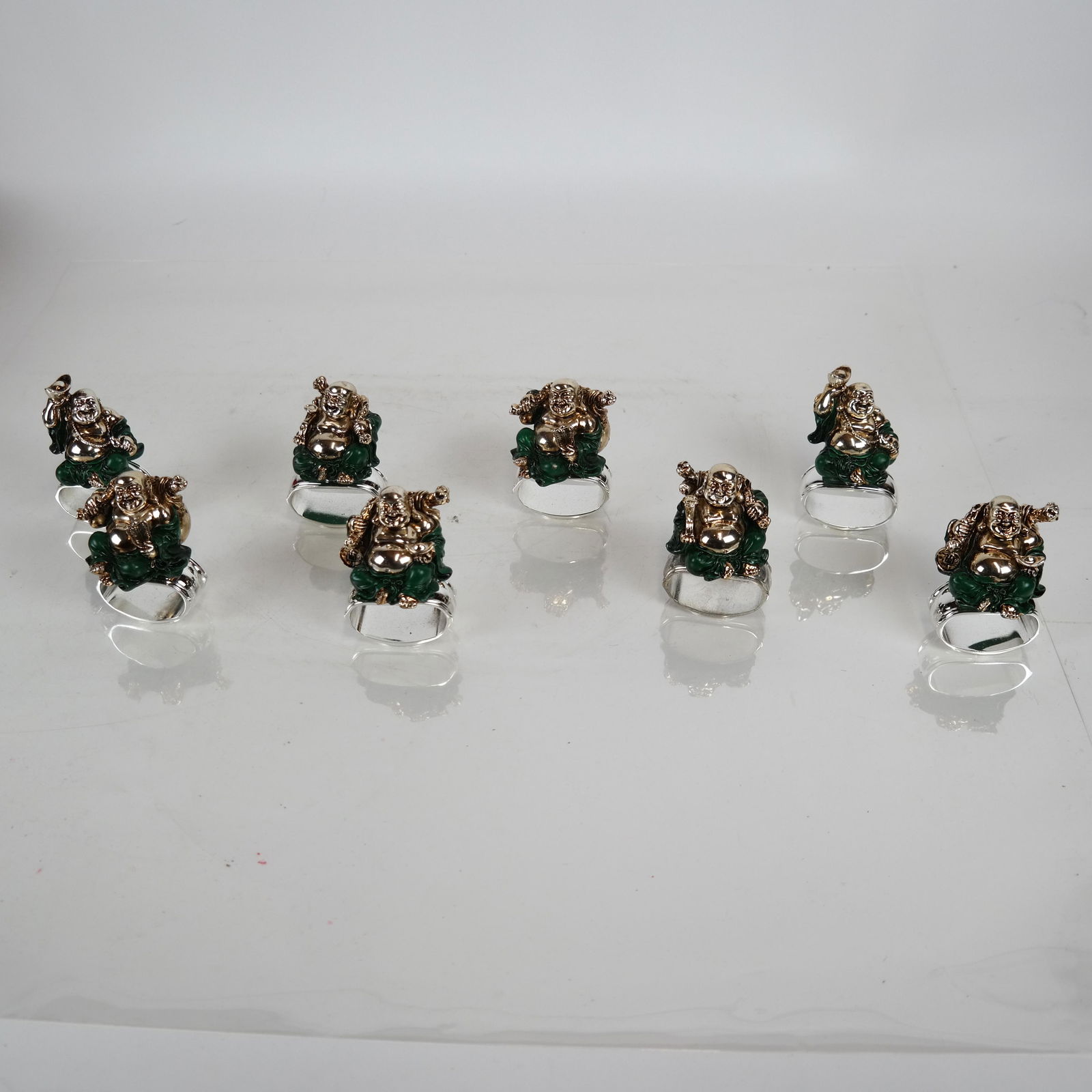 Hans Turnwood: 8 Buddha Napkin Rings: Hans Turnwood Signature Collection, Miami & Paris, two boxed collections of four each [3 1/2 inches high].