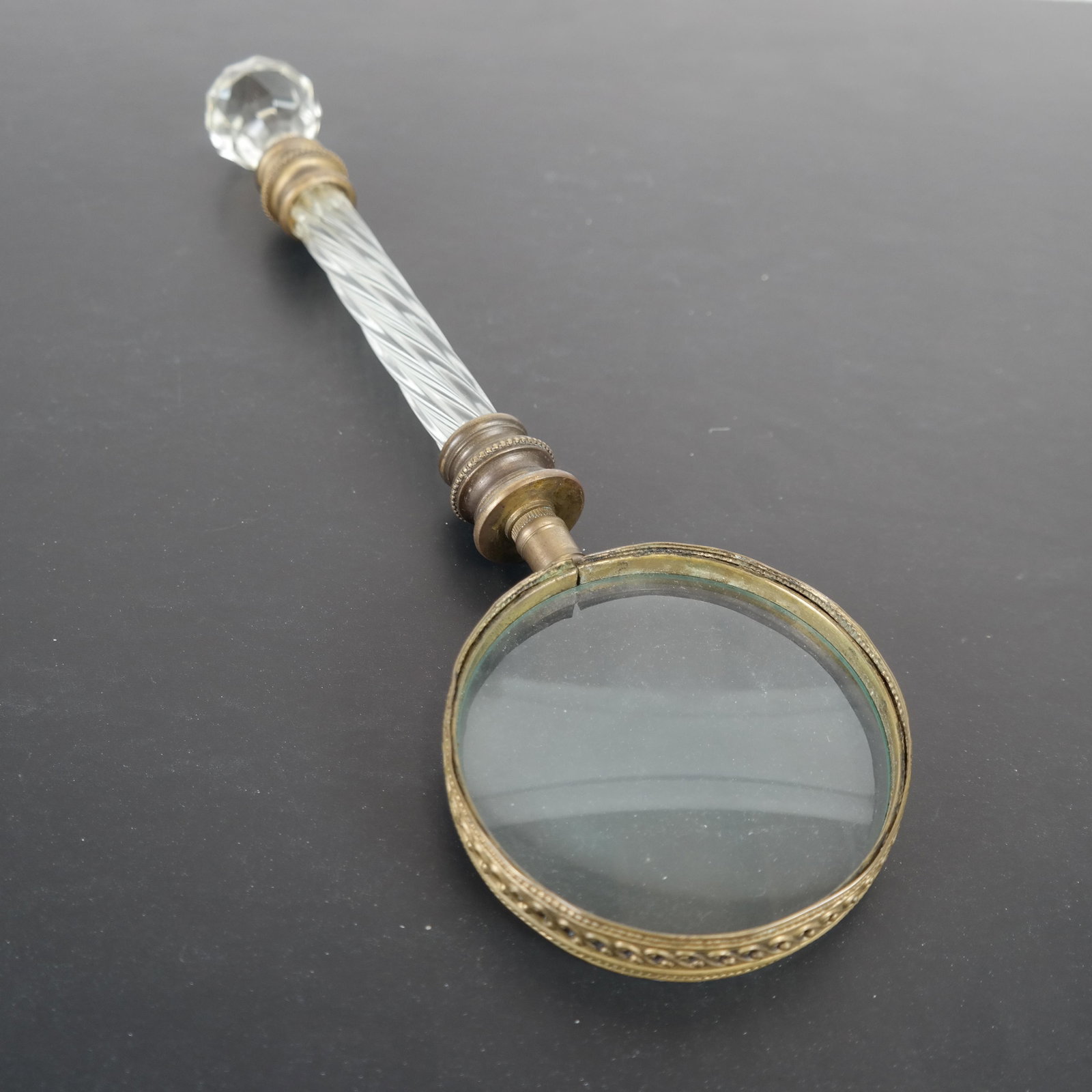 Baccarat Magnifying Glass: A bronze and crystal magnifying glass. [12 1/2 x 3 1/2 (dia) inches].