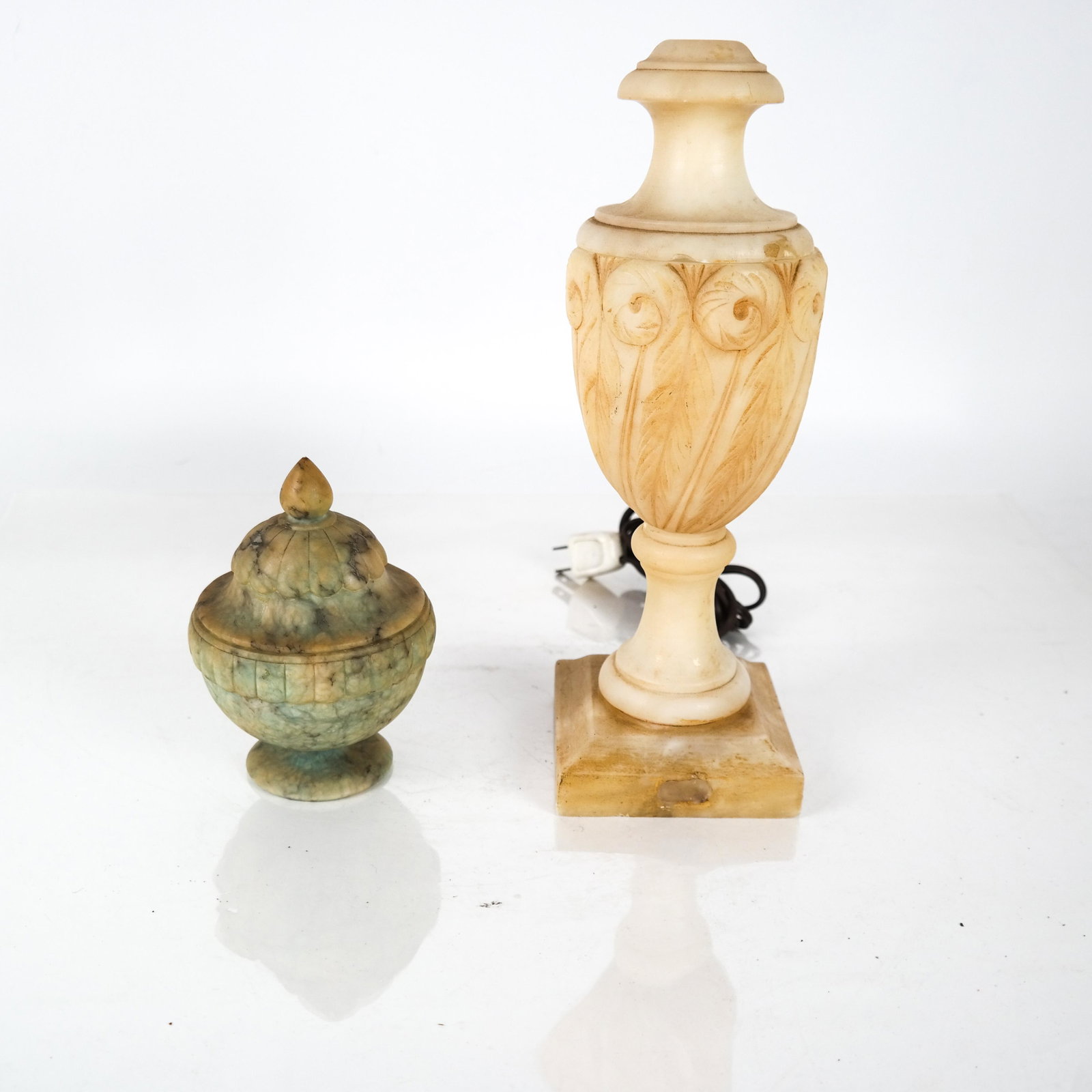 Alabaster Lamp and Vessel: Alabaster lamp and vessel, each with a cover; top of lamp drilled, not tested. [12 x 4 x 4 inches; 5 x 3 1/2 (dia) inches]. Both in overall good condition.