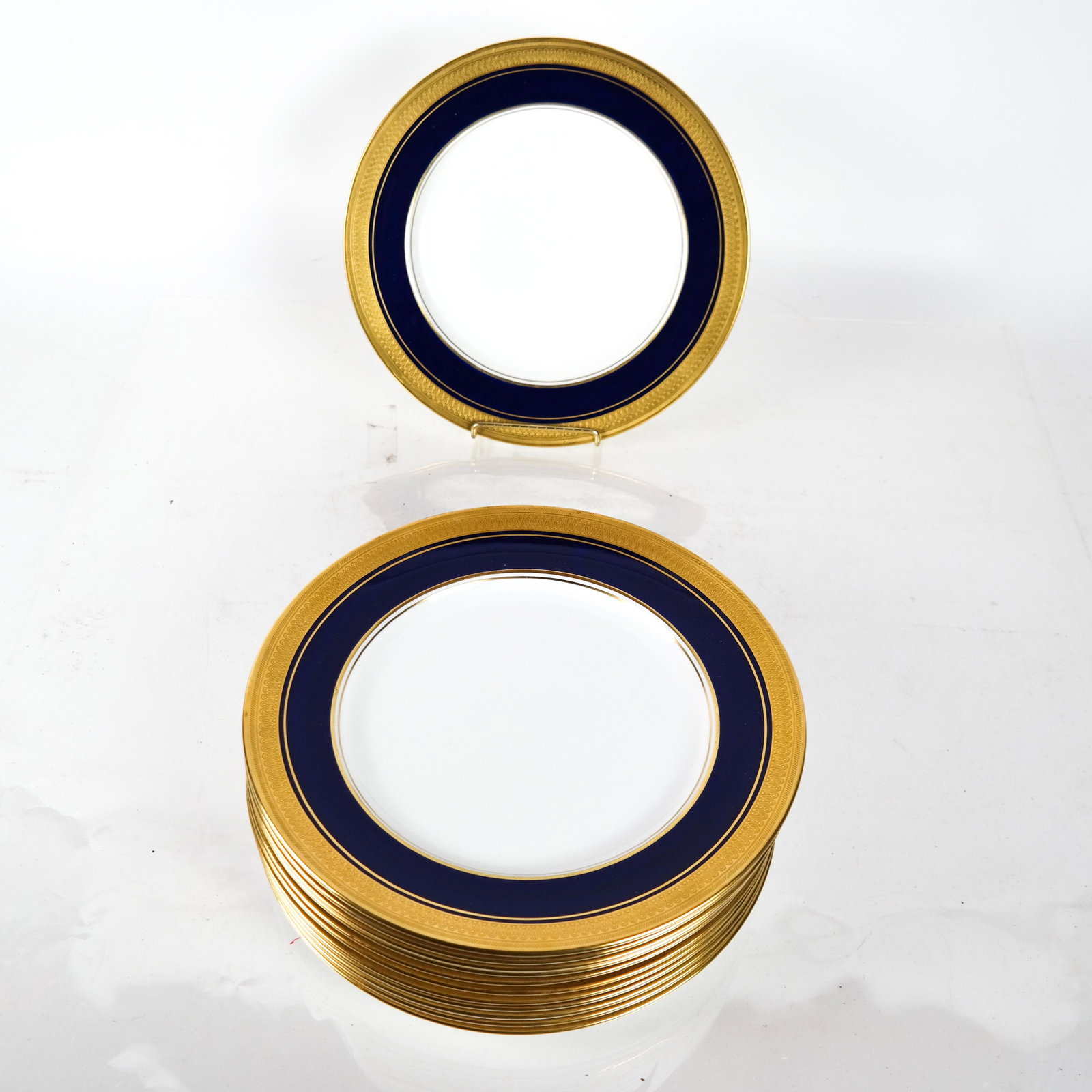 Twelve Ansley, England Porcelain Dinner Plates: 12 Ansley, England porcelain dinner plates in cobalt blue and white with gold borders. [10 1/2 (dia) inches].