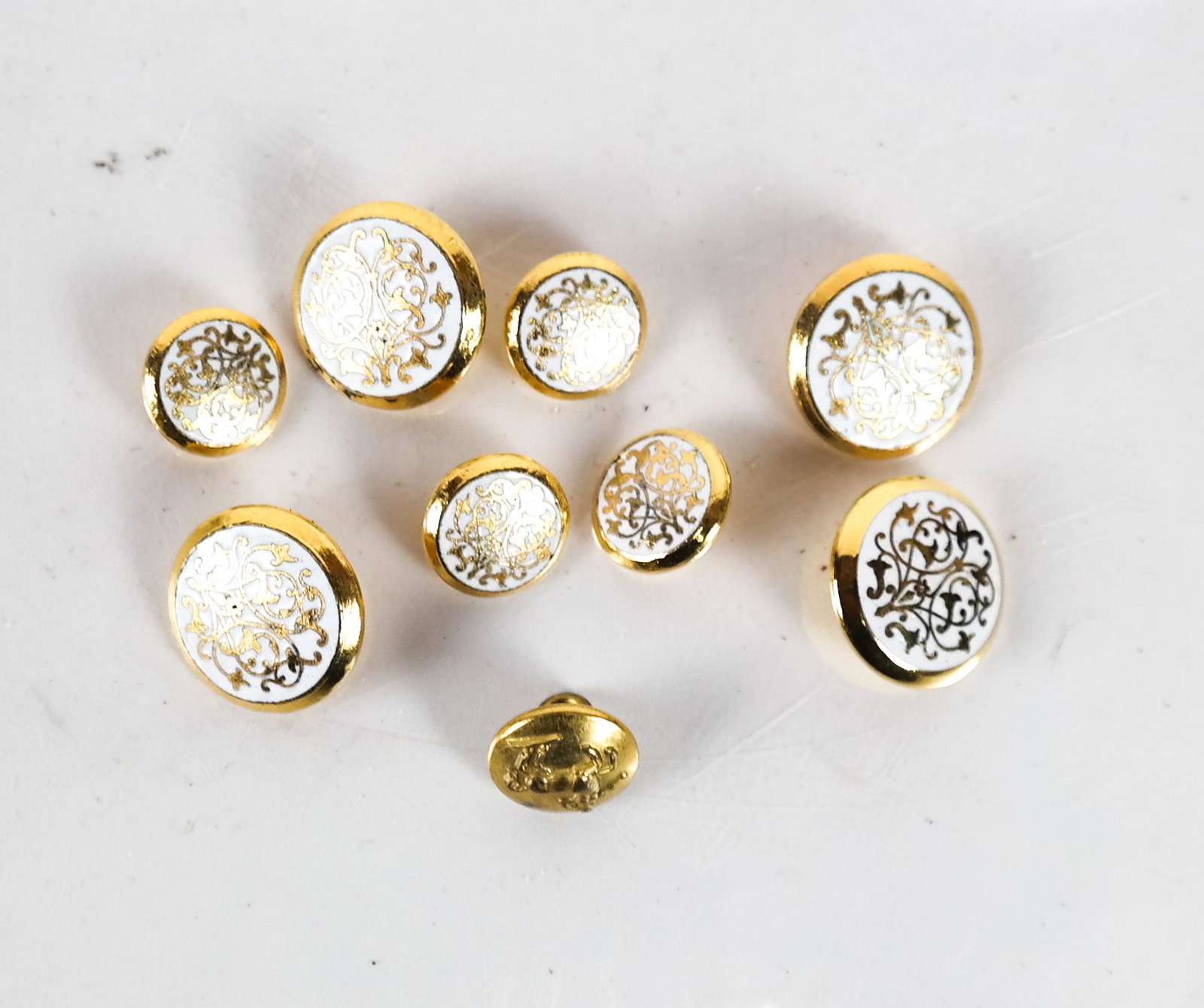 8 Ceramic Buttons & a Firmin London Uniform Button: 8 gold tone and ceramic shank buttons, in two sizes [15 mm and 20 mm], together with a vintage 1980s shank uniform button marked "Firmin" and "London" on reverse, with mythological centaur on front [a