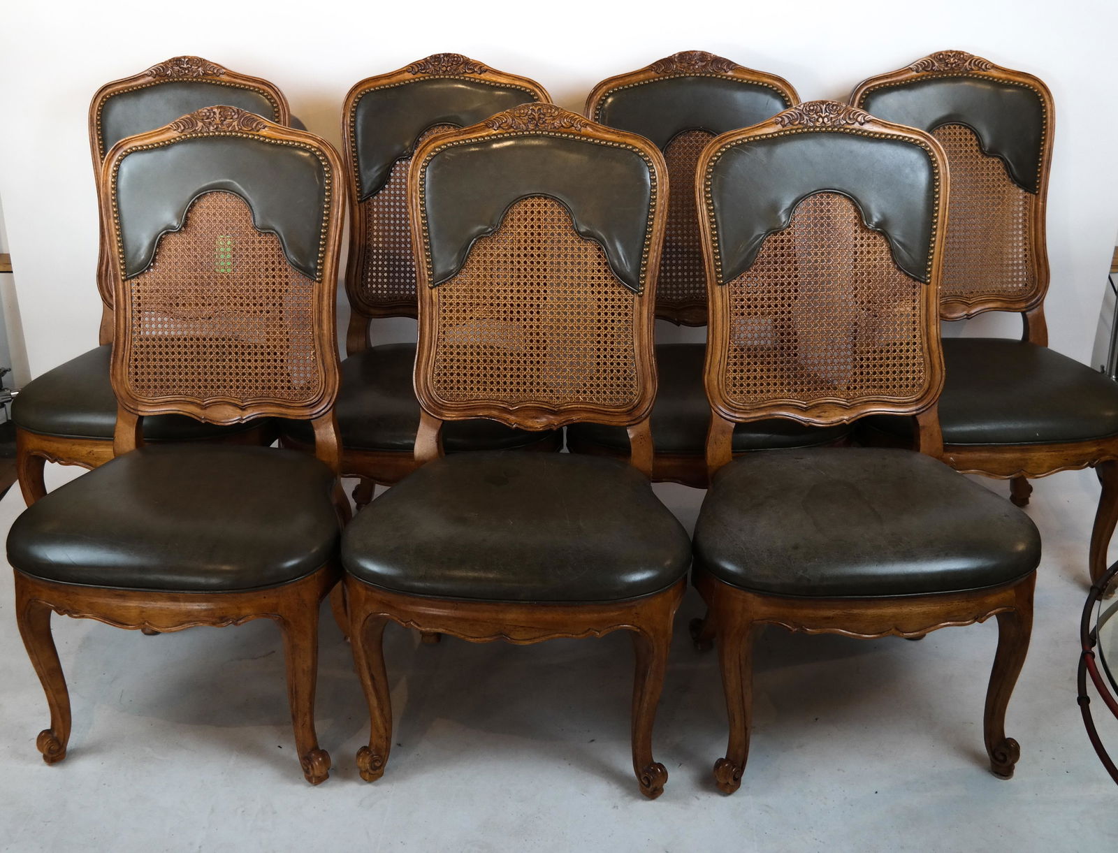 7 Provincial-Style Side Chairs: 7 Louis XV-style caned back chairs. [42 1/2 x 23 x 19 inches; 17 1/4 inches to seat]. In good condition.