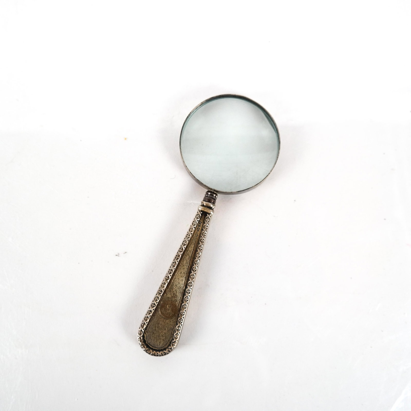 Silver Magnifying Glass: Silver magnifying glass with monogram. [6 3/4 inches long].