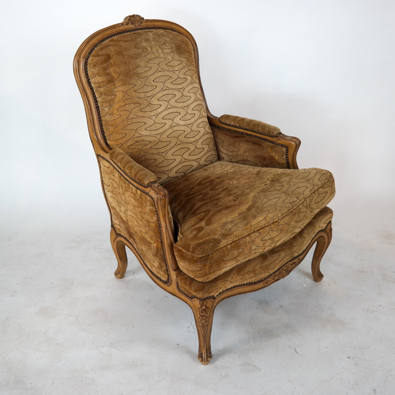 Louis XV-Style Painted Bergere: Louis XV-style painted bergere with upholstery and cushion. [41 1/4 x 29 x 20 inches]. Moderate wear to cushion and upholstery.