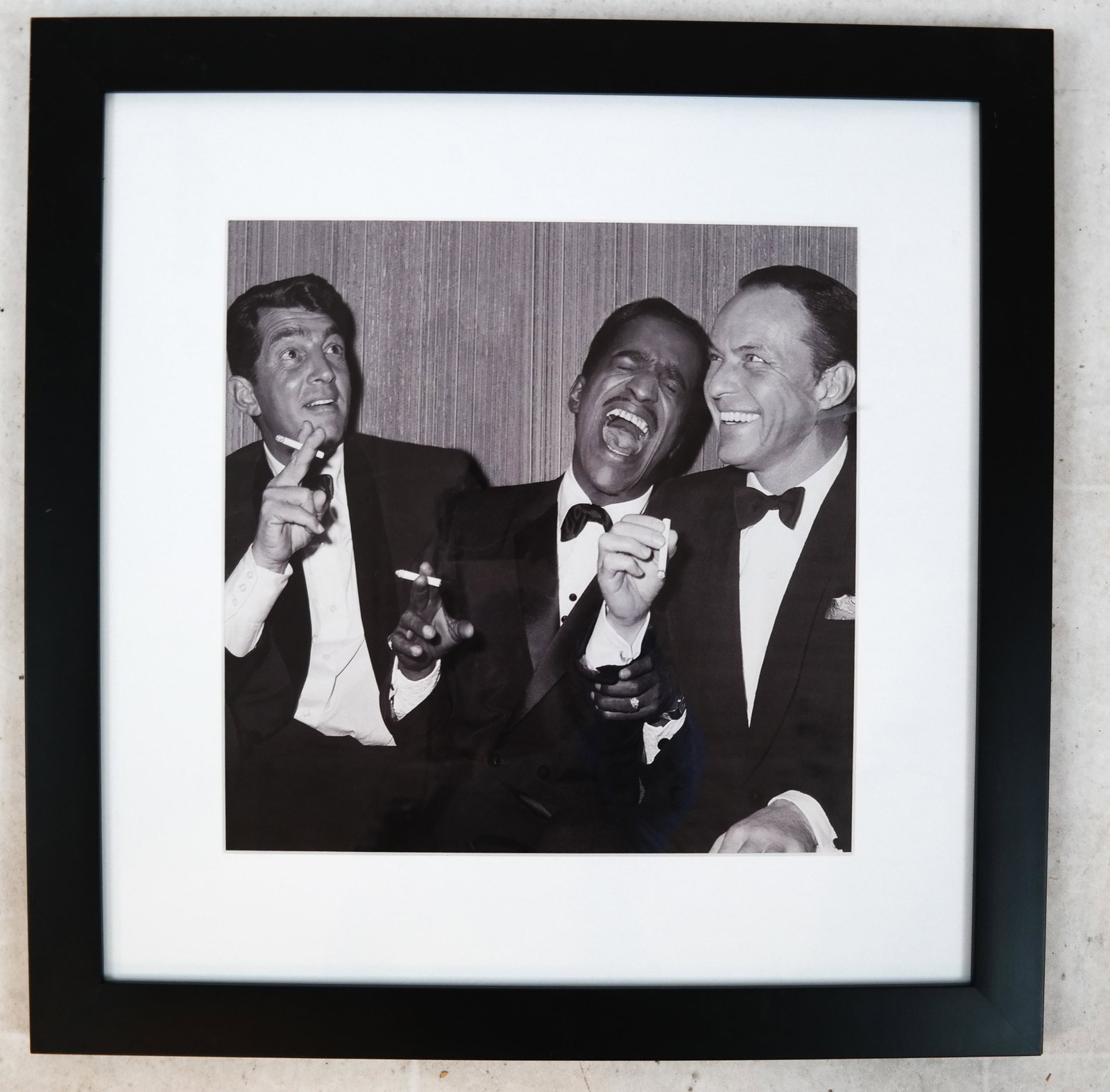The Rat Pack - Black and White Photograph: Black and white photograph of Dean Martin, Sammy Davis, Jr., and Frank Sinatra. [Art: 12 x 12 inches; Frame: 21 x 21 inches]. In good condition.