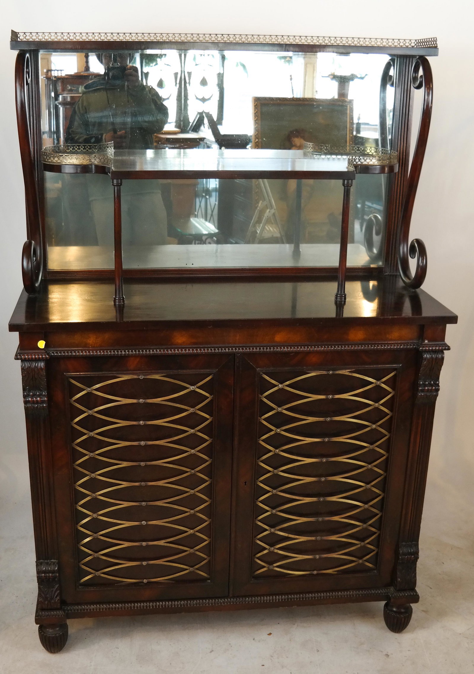 Regency-Style Credenza/Etagere: Regency-style mahogany chiffonier with brass grilles and mirrored back. [63 x 42 x 17 inches].