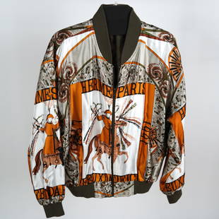 HERMES Reversible Silk Bomber Jacket: A vintage Hermes silk bomber jacket, reversible to solid brown, size L. [50" chest, 25" from shoulder to waist]. Light pilling to knit cuffs and waistband; 5 tiny white spots (1/16") to left front. On