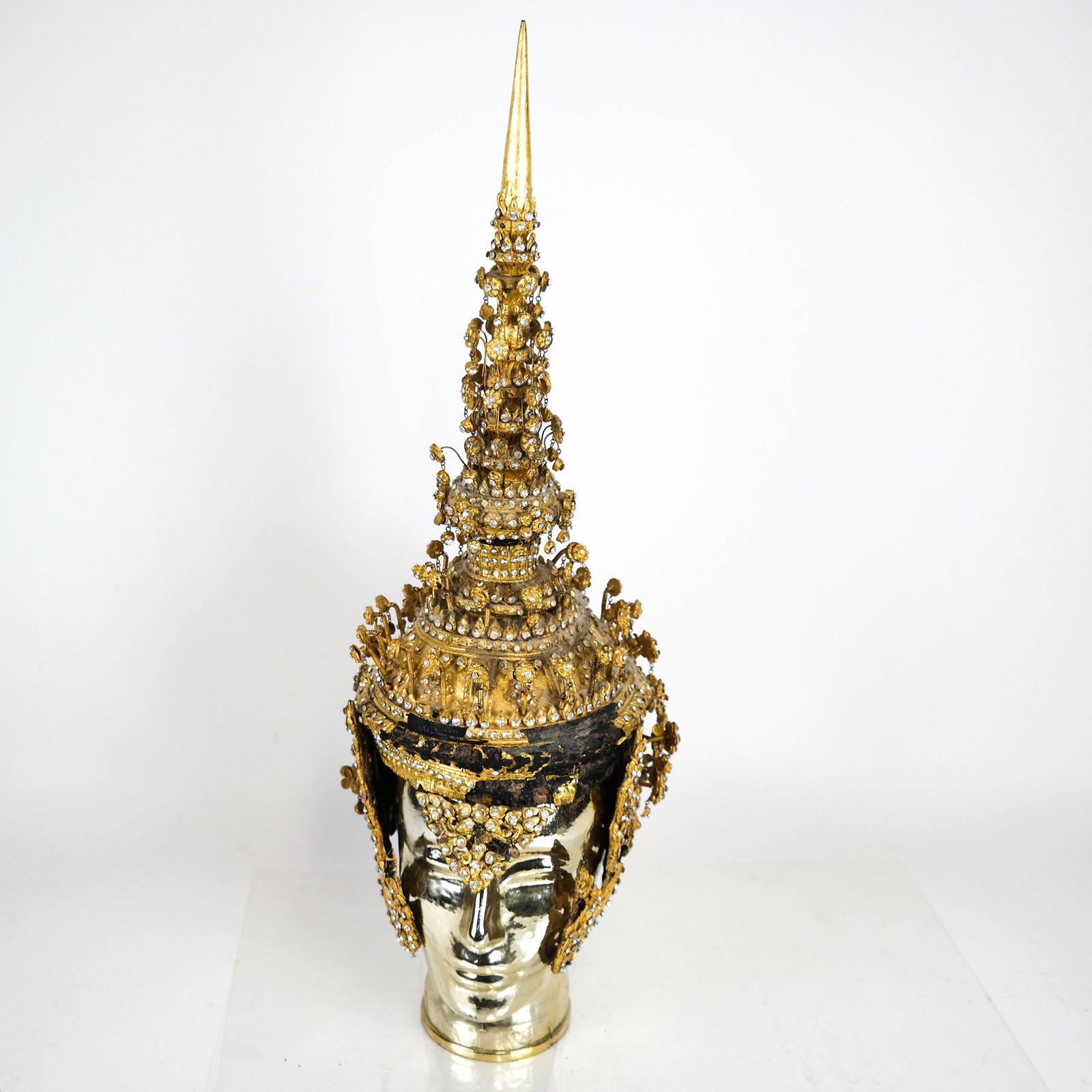 Antique Thai Headdress: Antique decorated wood and papier mache Thai headdress in two parts. NOTE: GLASS HEAD NOT INCLUDED IN LOT.[Cap: 10 1/2 x 7 (dia) inches; Finial: 11 1/2 inches high]. Losses.