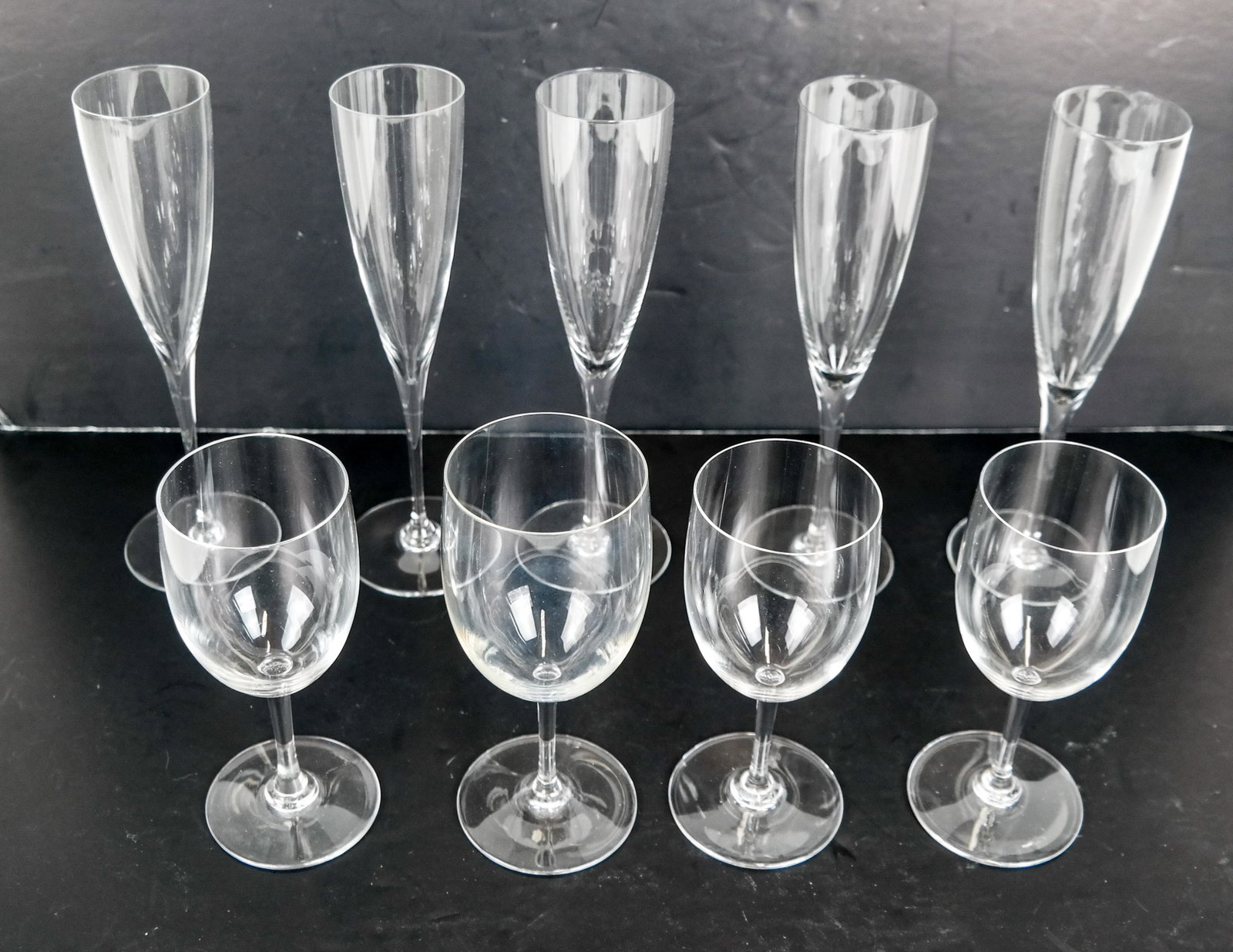 9 Baccarat Crystal Glasses: 9 Baccarat crystal glasses, including 5 champage flutes and 4 wine glasses. All in good condition.