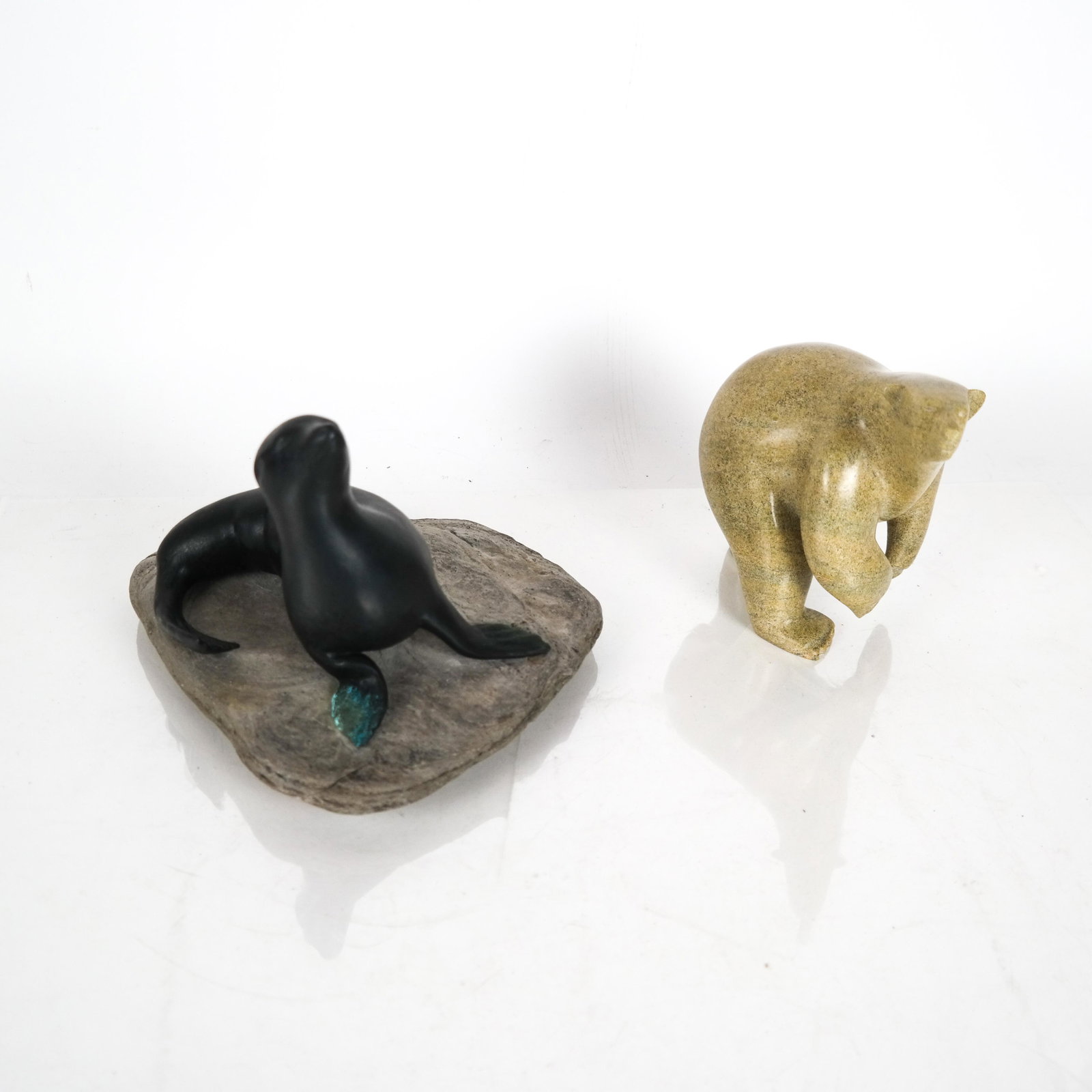 Inuit-Style Polar Bear, Seal: A stone polar bear by Qiatsag Shea, Cape Dunster [5 x 6 x 3 inches] and a stone seal [6 x 7 1/2 x 7 inches].