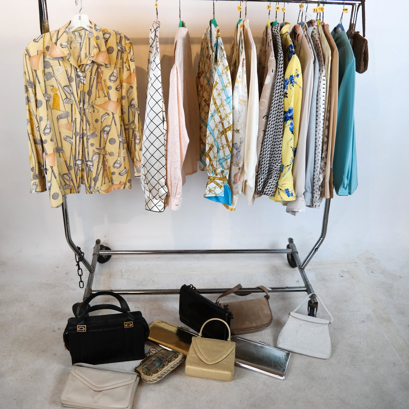 Box Lot of Ladies Blouses and Purses: Lot includes 17 ladies\\\' blouses (all labels removed), various sizes and patterns, all dry-cleaned, and 11 purses and bags, in leather, beaded and suede, including one Ferragamo and one Walborg. All