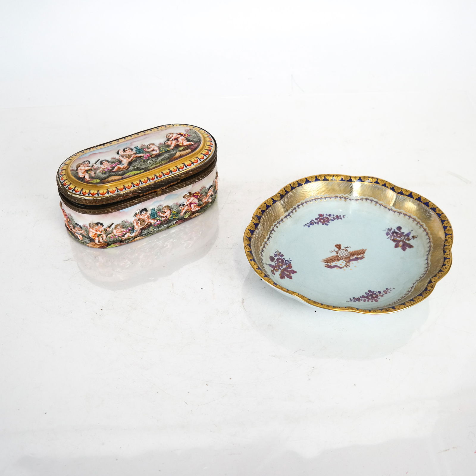 Capodimonte Box, Other: A hinged, porcelain relief box with cherubs, and a reproduction Mottahedeh dish. [Box: 2 3/4 x 6 x 3 inches; Dish: 1 x 8 x 6 1/2 inches].