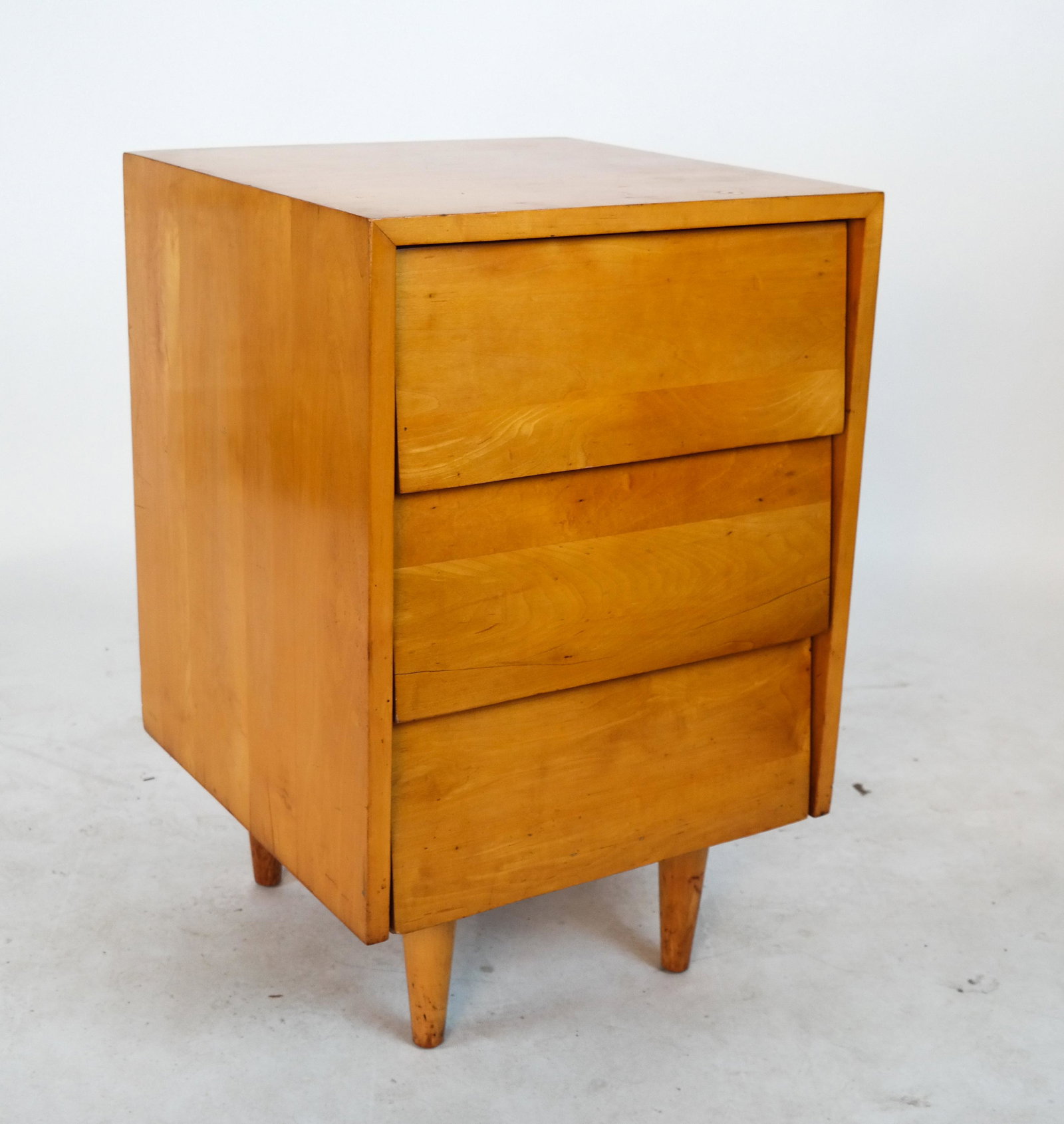 Knoll Associates Modern Stand: 20th century modern Knoll Associates, Inc. end stand, with three drawers. Lower right drilled. [28 x 18 x 18 inches].