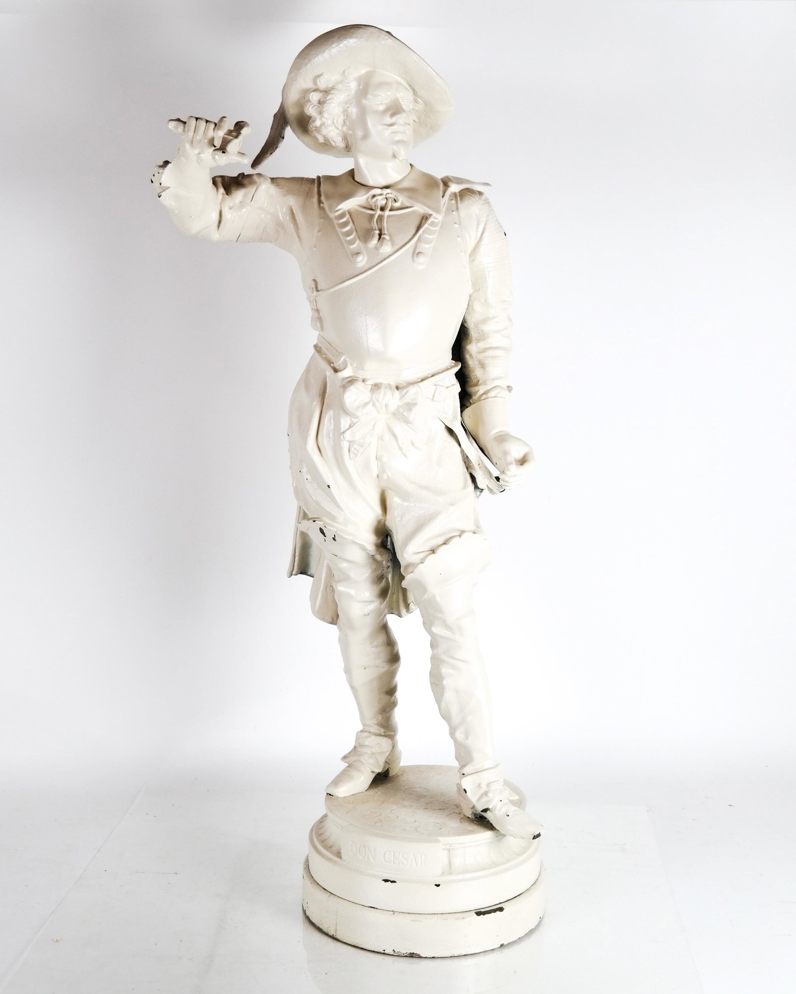 Painted White Metal Cavalier Sculpture: Painted sculpture in white metal, of Don Cesar, cavalier. [36 1/2 x 15 x 10 (dia) (base) inches]. In good condition.