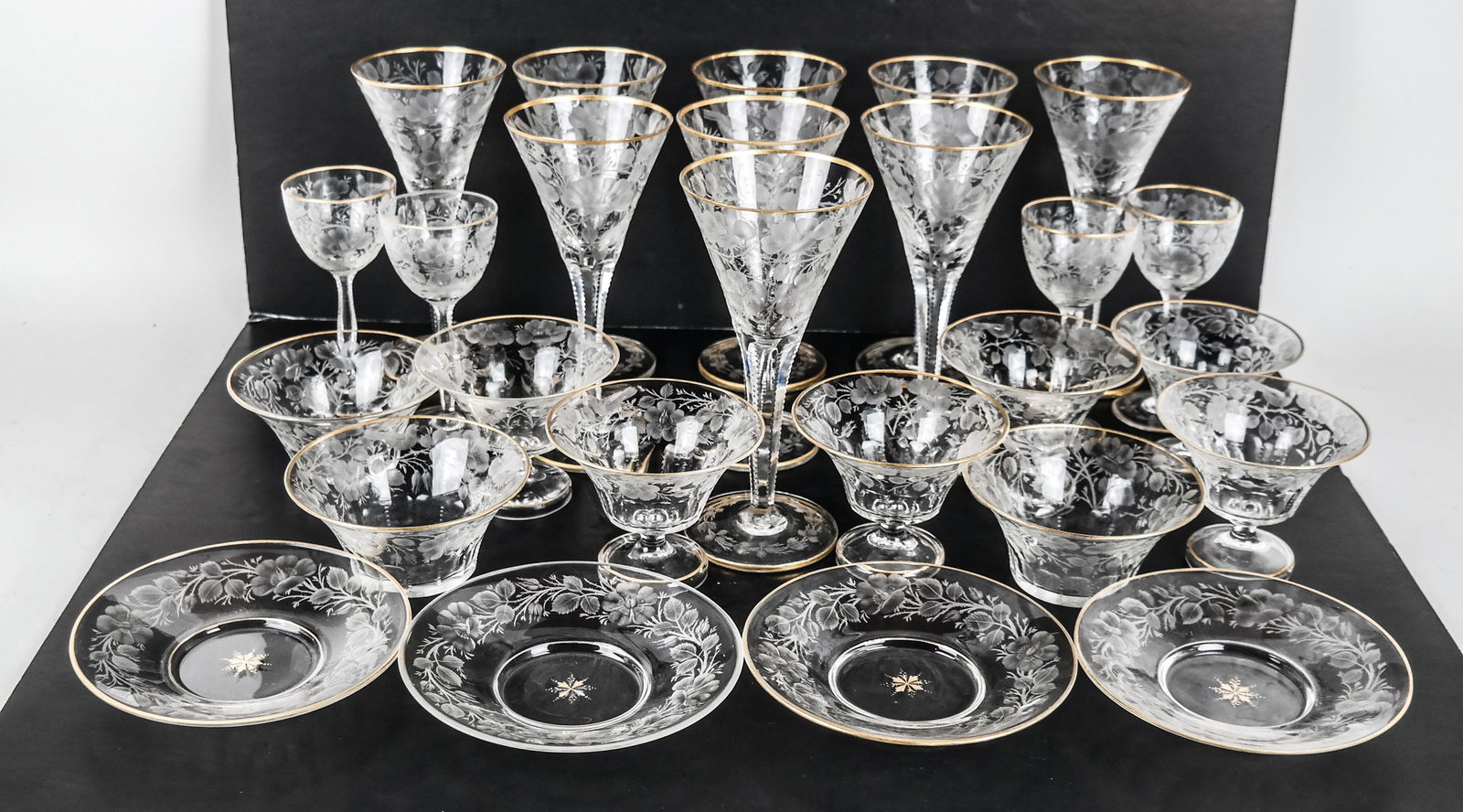 45 Pcs. Venetian-Style Etched, Incised Stemware: 45 pieces of Venetian-style stemware, including 9 wine glasses [8 x 3 3/4 inches], 4 cordials [6 x 2 1/2 (dia) inches], 11 parfaits [3 1/2 x 4 1/2 (dia) inches], 12 bowls [2 1/2 x 5 (dia) inches], and