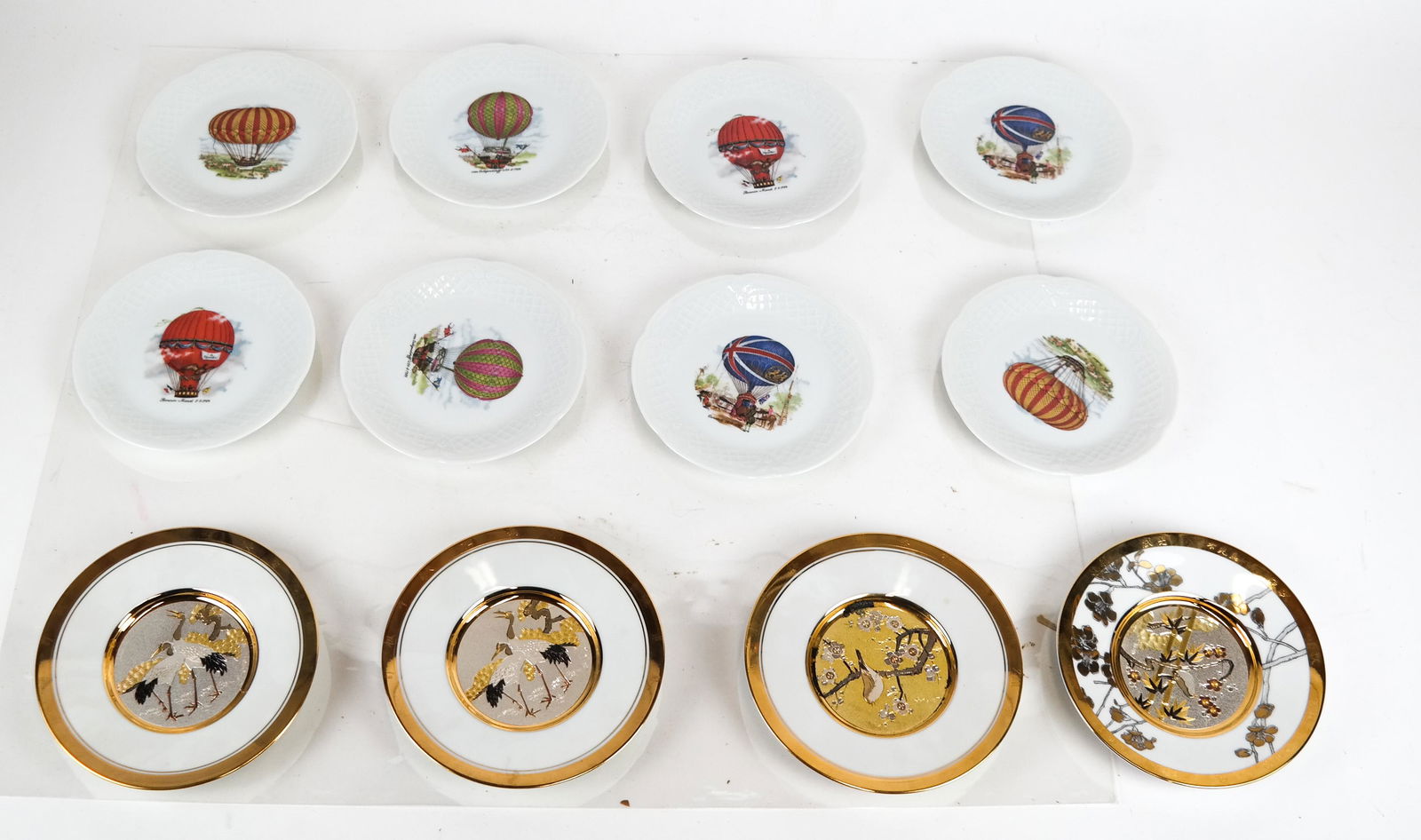 8 Limoges Saucers and 4 Other Saucers: 8 "Phillipe De Shoulieres" Limoges balloon design saucers and 4 (of 12) "Friendship" plates by The Hamilton Collection. [5 3/4-6 (dia) inches]. In overall good condition.