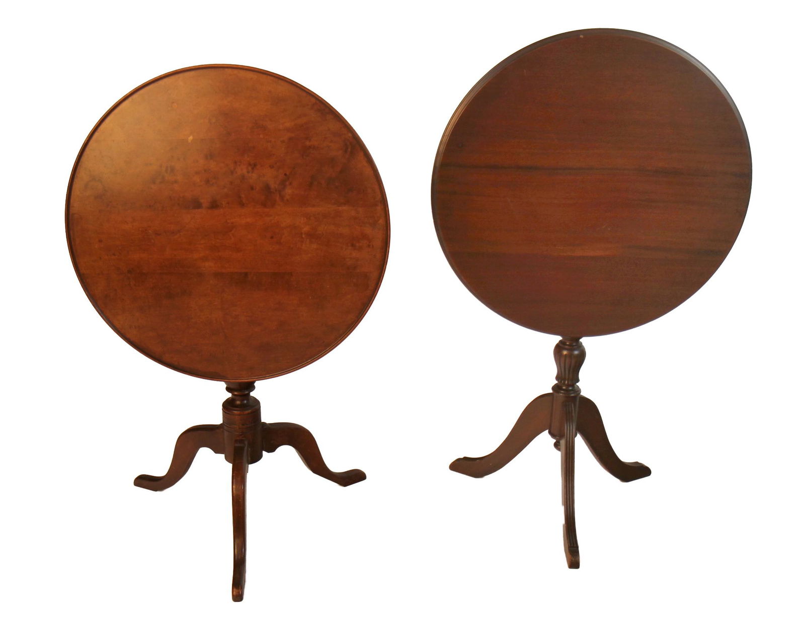 Two Mahogany Tilt-Top Tables: Two mahogany tilt-top tables. [40 (closed) x 24 (dia) (top) inches; 38 (closed) x 24 (dia) inches]. Scratches; one with a long scratch.
