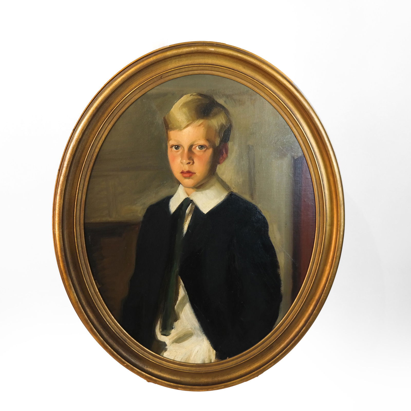 Louis BETTS: Portrait of a Boy - Oil on Canvas: Louis Betts (American, 1873-1961) portrait of a boy, in oval frame. Label on verso states that it is a fragment of larger portrait of a boy and girl. [Art: 28 x 22 inches; Frame: 33 x 27 inches]. In g