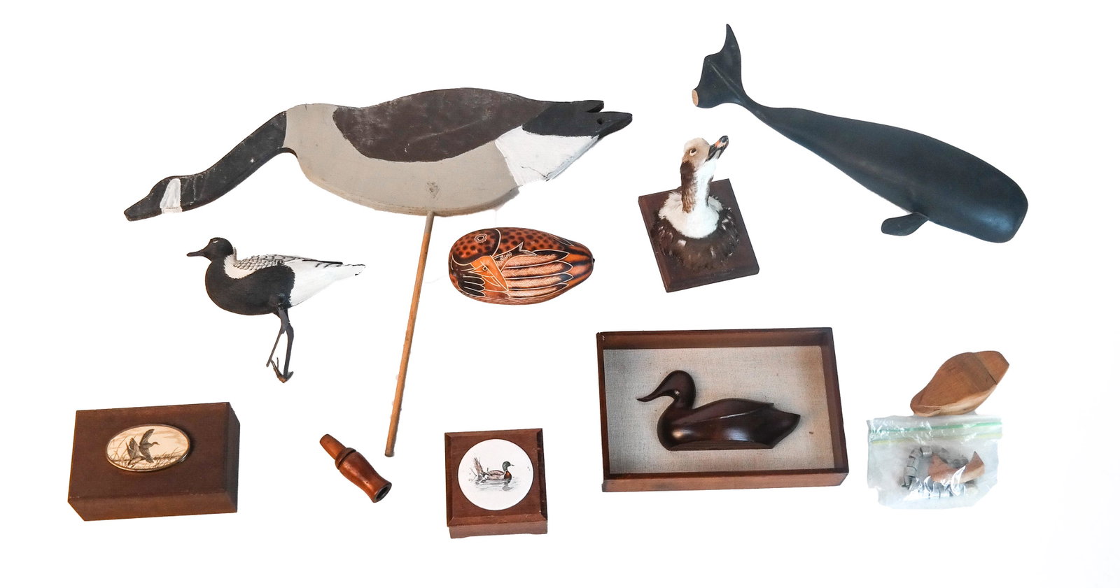 Mixed Lot of Carvings, Boxes, Taxidermy, Others: Group comprised of wooden carvings, boxes and taxidermy, all duck-themed, together with a duck call, a whale carving (dorsal fin broken off but present), a goose on a stick, and some metal wildlife ta
