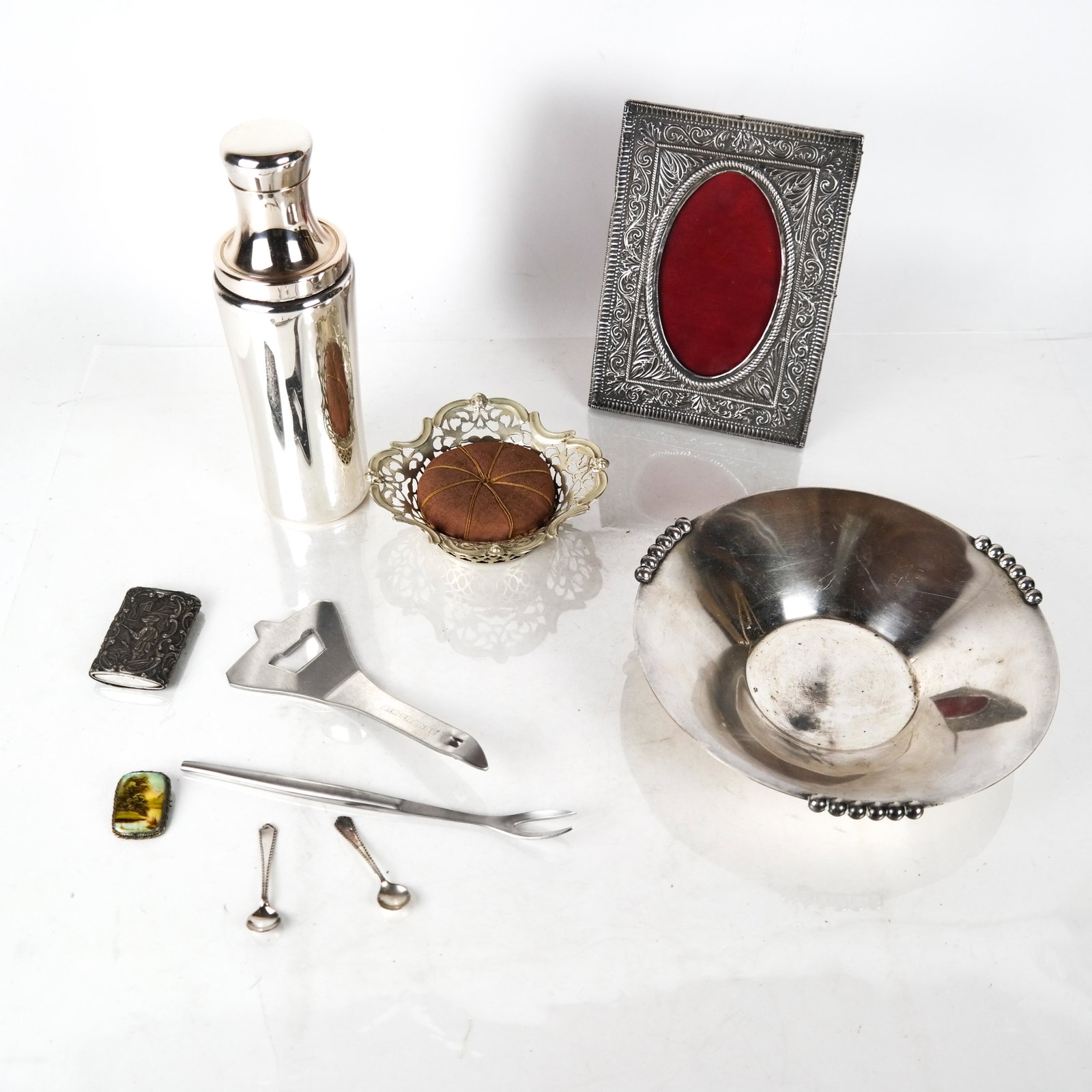 Lot of Silver Plate Articles: Lot includes a martini shaker, a photo frame, a dish and a pin cushion.
