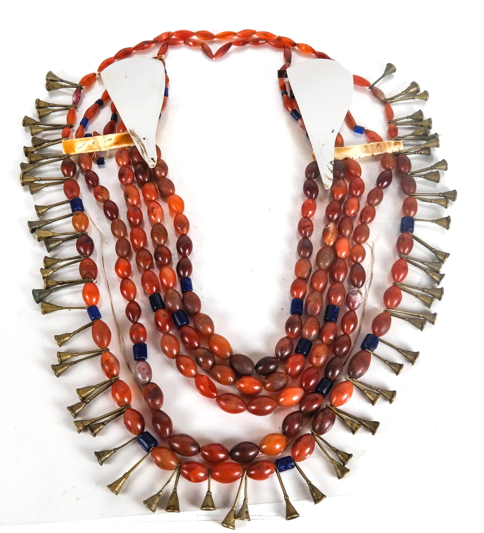 Tribal Carnelian, Bone and Whelk Shell Necklace: Tribal necklace of large carnelian beads, bone and whelk shells. Elements need re-stringing.
