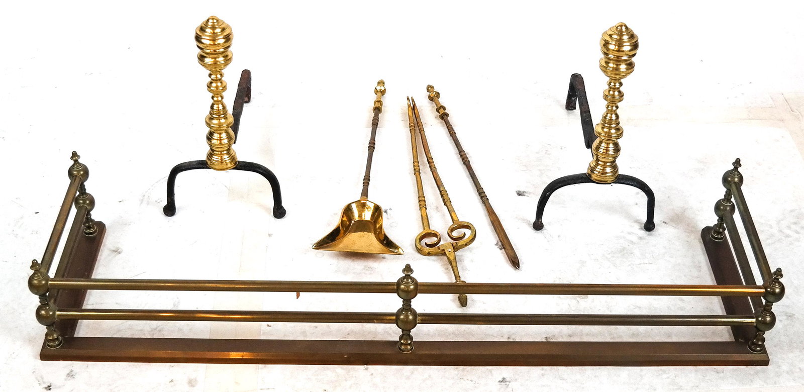Group of Fireplace Equipment: A fire fender, pair of andirons and tools; no base. [Fender: 7 x 41 1/2 x 12 inches; Andirons: 15 x 8 x 16 inches; Tools (largest): 23 x 3 1/2 inches].