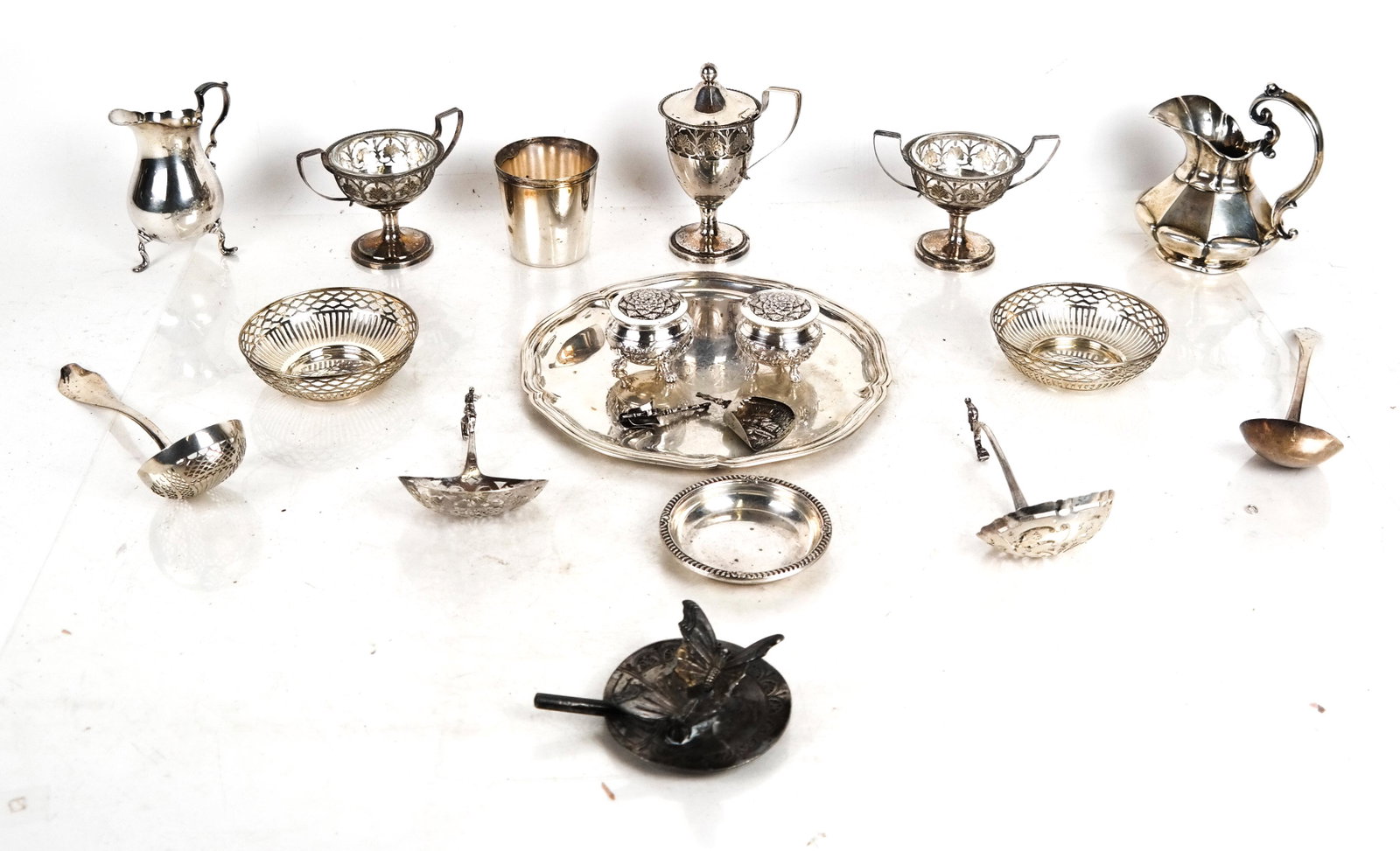 Lot of Silver Plate Table Articles: Lot of silver plate table articles, including salts, shakers, creamers, spoons, cups, a tray, and others.