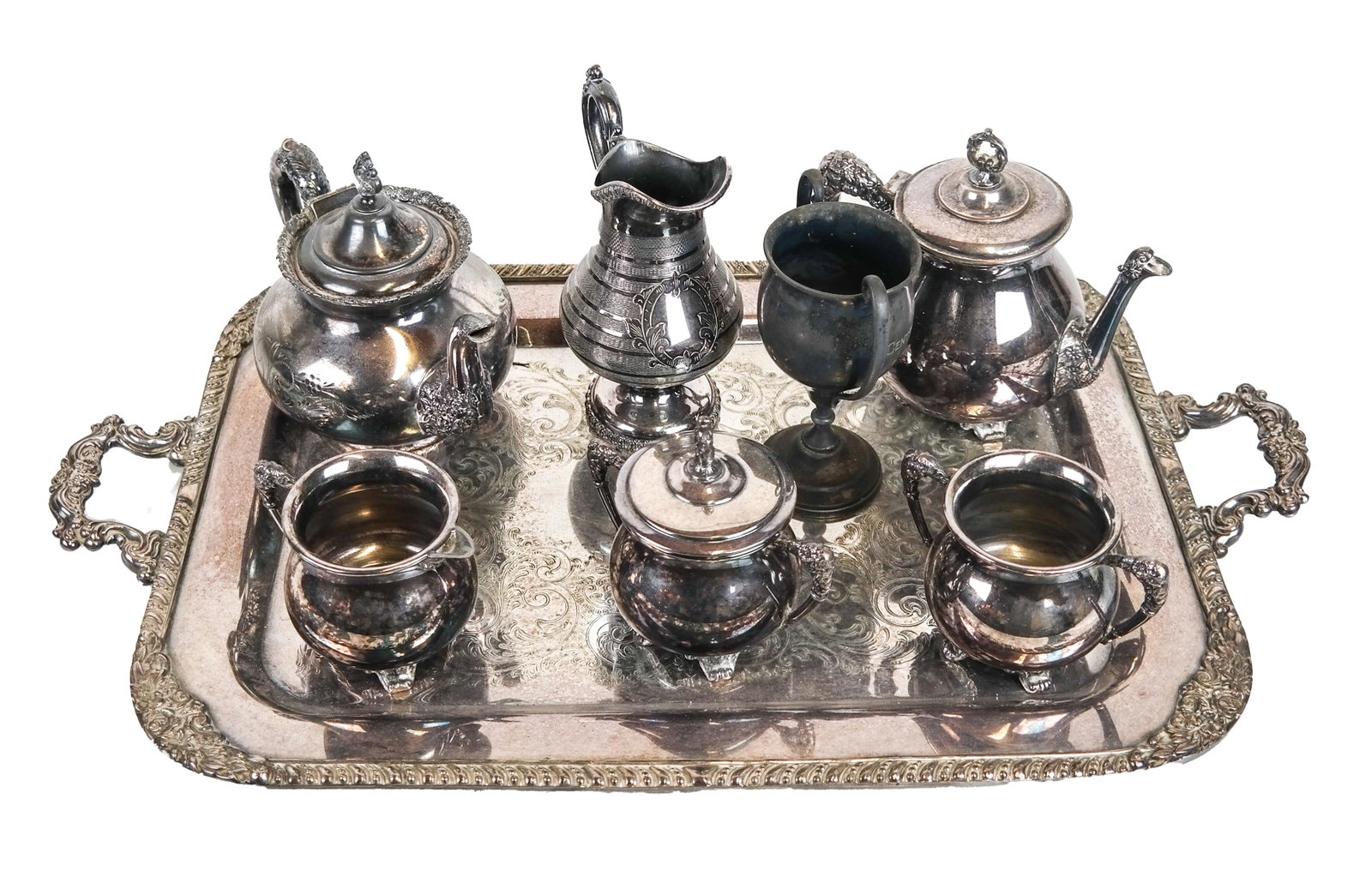 4 Pcs. Silver Plate Tea/Coffee Ware: A four-piece silver plate tea set, a tray, trophy cup, teapot, pitcher. [Tray: 25 3/4 x 15 inches; Pots (largest): 6 1/2 x 9 1/2 inches].
