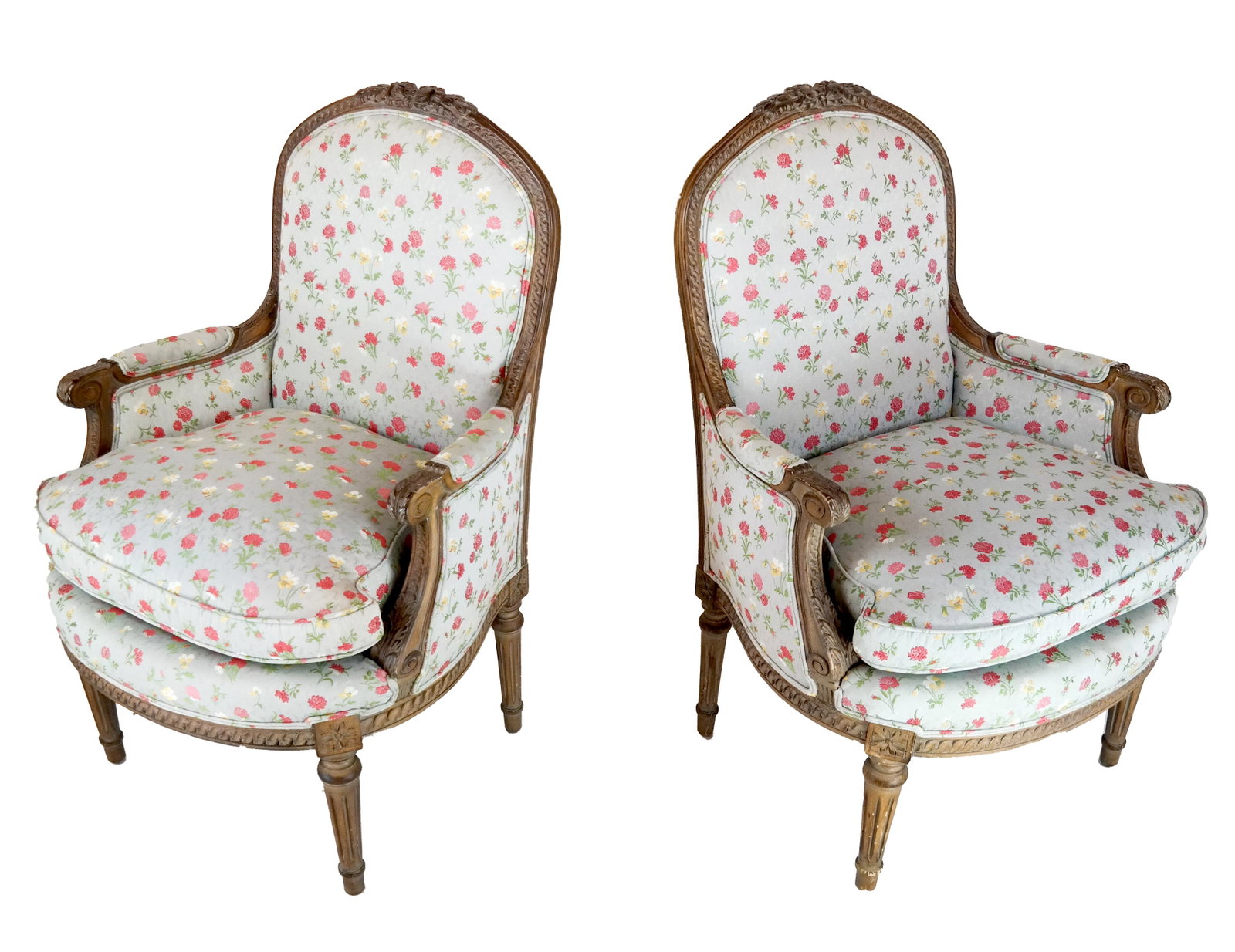 Pair Louis XVI-Style Pickled Bergeres: Pair of 20th century Louis XVI-style pickled carved walnut bergeres, nicely upholstered in a floral fabric. [40 1/2 x 28 x 22 inches; 19 inches to seat]. In good condition.