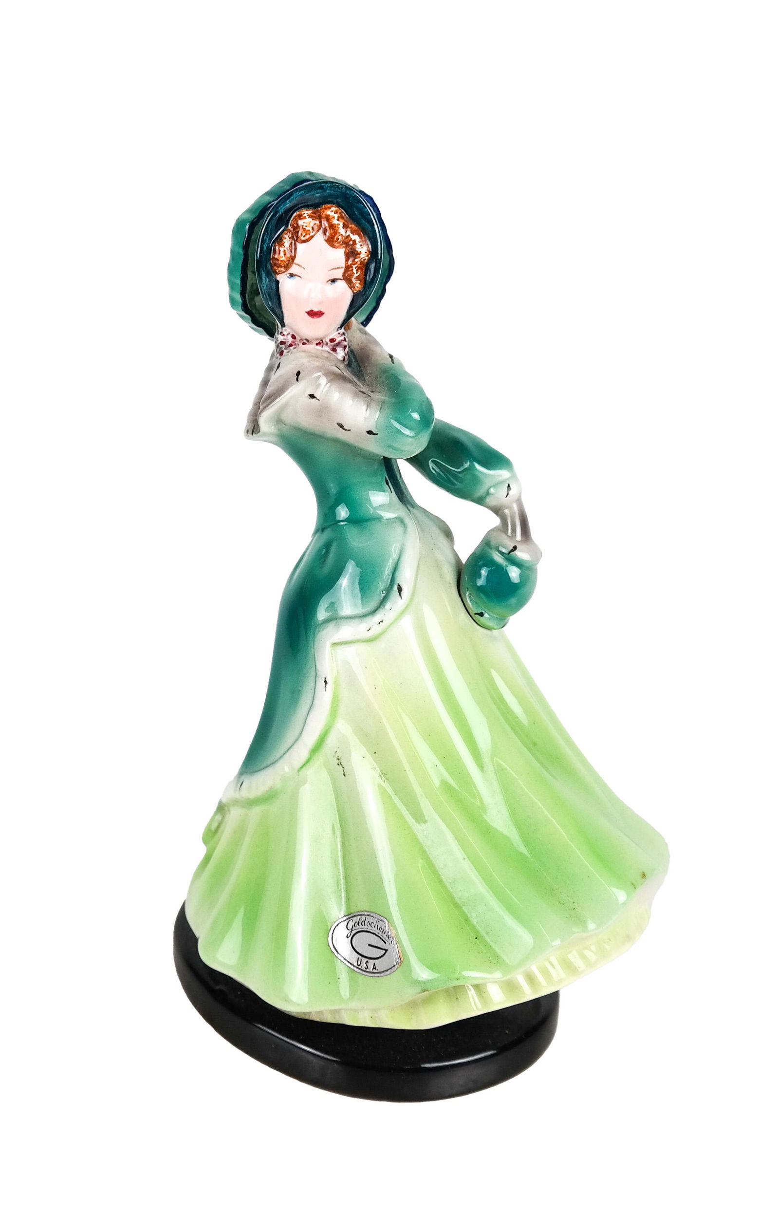 Goldscheider Porcelain Lady: Painted porcelain lady holding an umbrella, stamped "Goldscheider Everlast Corp., 88-817". [8 1/2 x 5 x 4 inches].