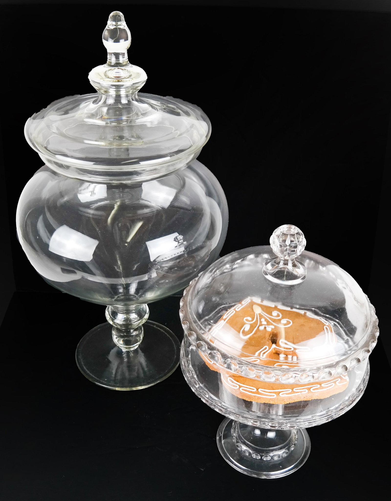 Glass Apothecary Jar and Cake Stand: Glass apothecary jar [23 x 12 (dia) inches] and a cake stand with a cover. [15 x 9 (dia) inches]. In good condition.