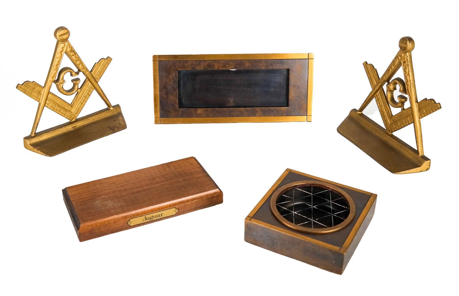 Brass Bookends, Ash Tray, Others (4): Brass compass bookends, initialed "G", a brass ash tray, a brass desk nameplate holder, and a wooden plaque marked "Jaguar". [Bookends: 7 x 6 3/4 x 2 1/4 inches].
