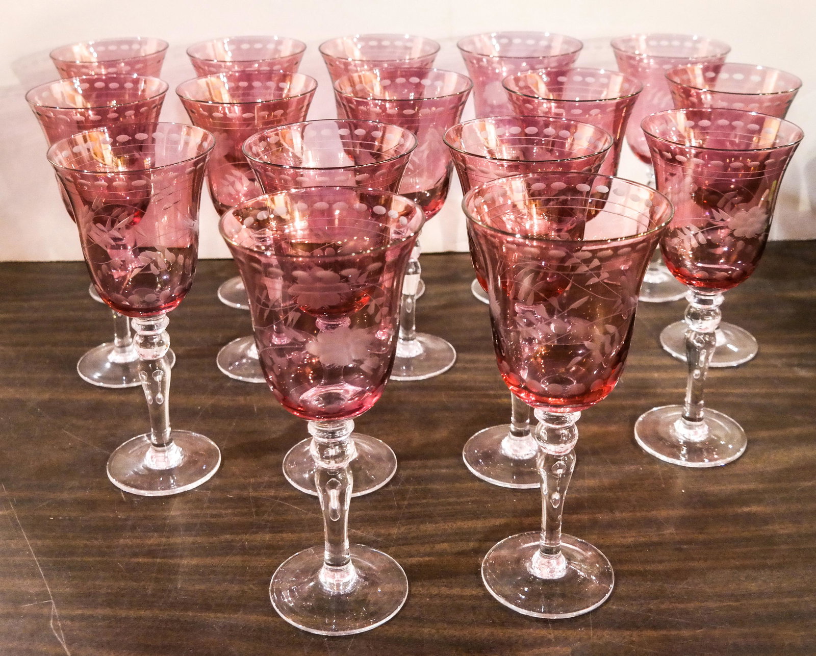 16 Deep Pink to Clear Etched Wine Glasses: 16 deep pink to clear etched wine glasses. [8 1/8 inches high].