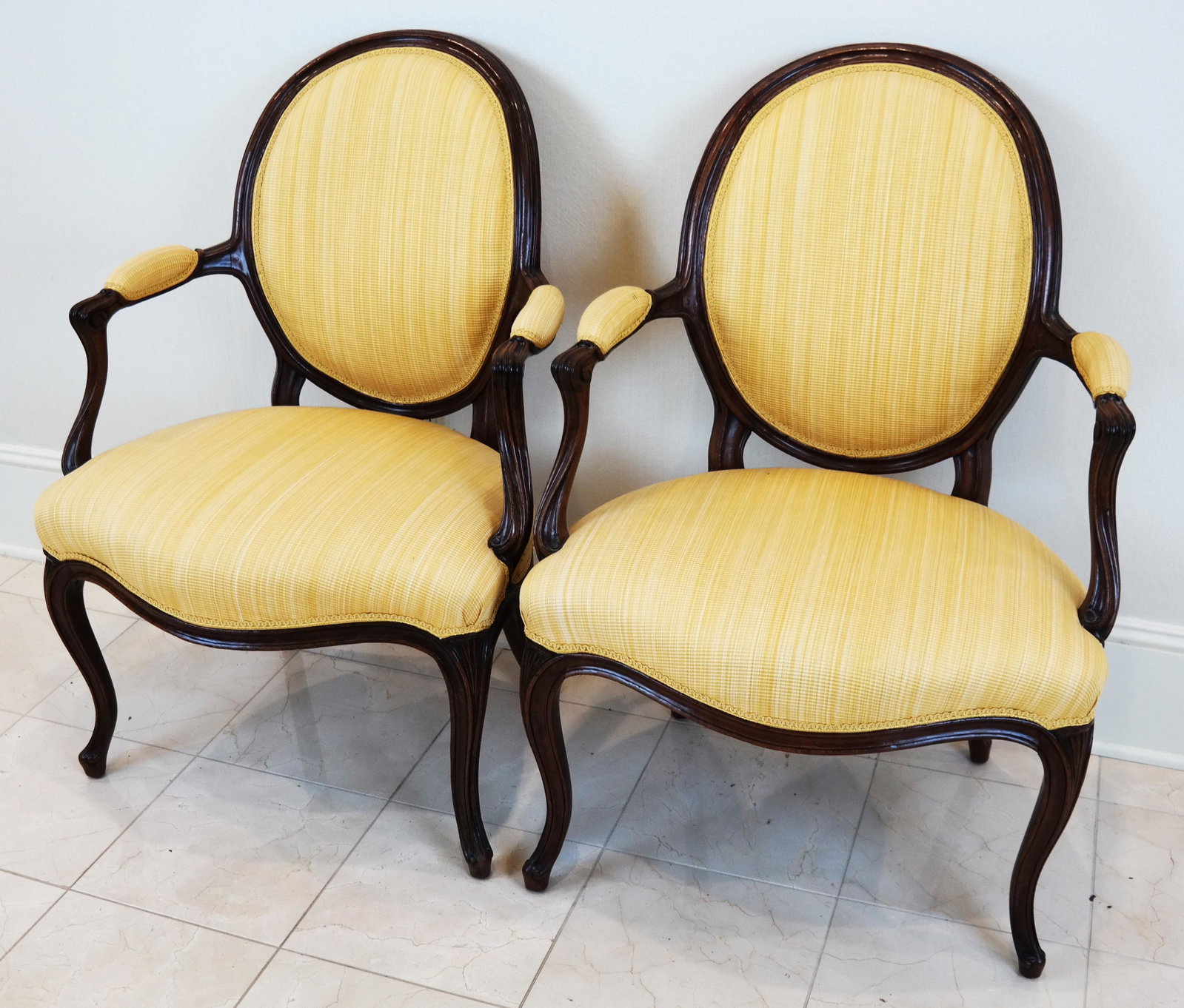 Pair of George III Mahogany Arm Chairs: Pair of George III solid mahogany arm chairs, circa 1770, upholstered in yellow waffle fabric. [37 x 25 x 20 inches]. In good condition.