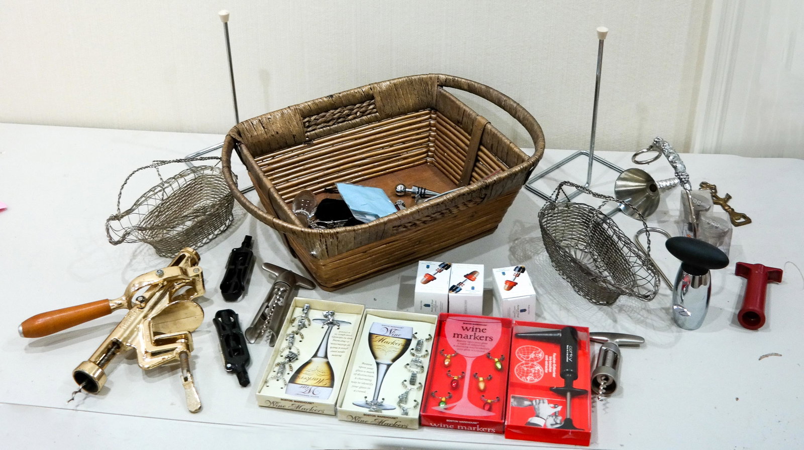 Assorted Lot of Wine-Related Items: Basket of items related to wine, including openers and barware.