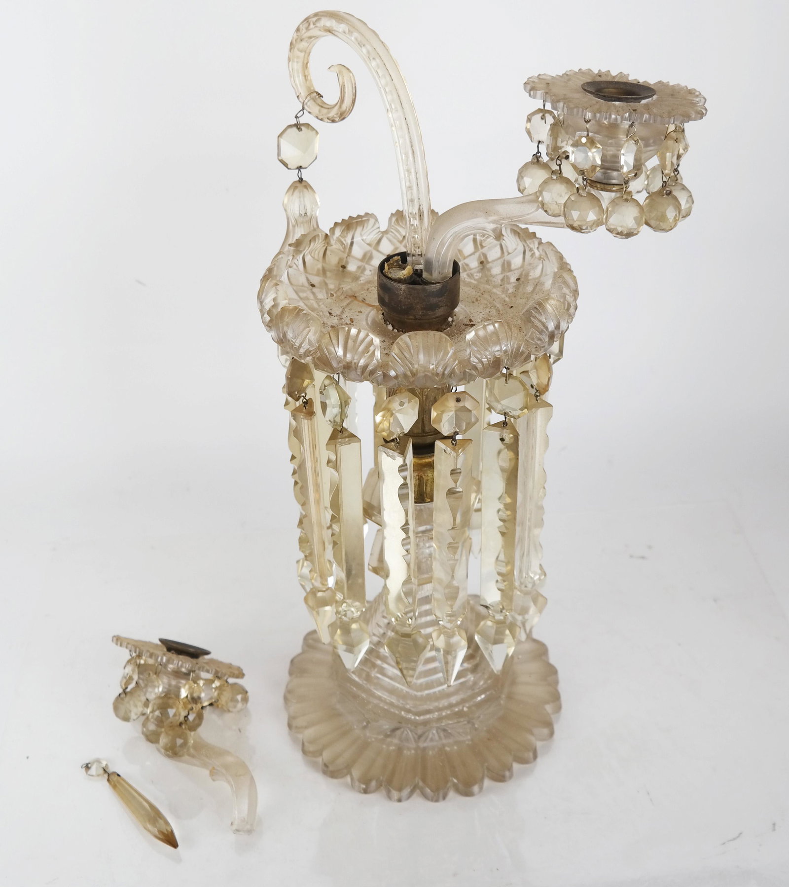 Cut Crystal Candelabra with Prisms: Cut and molded crystal candelabra with prisms, having two scrolling arms. [19" H]. One arm broken off, but present.