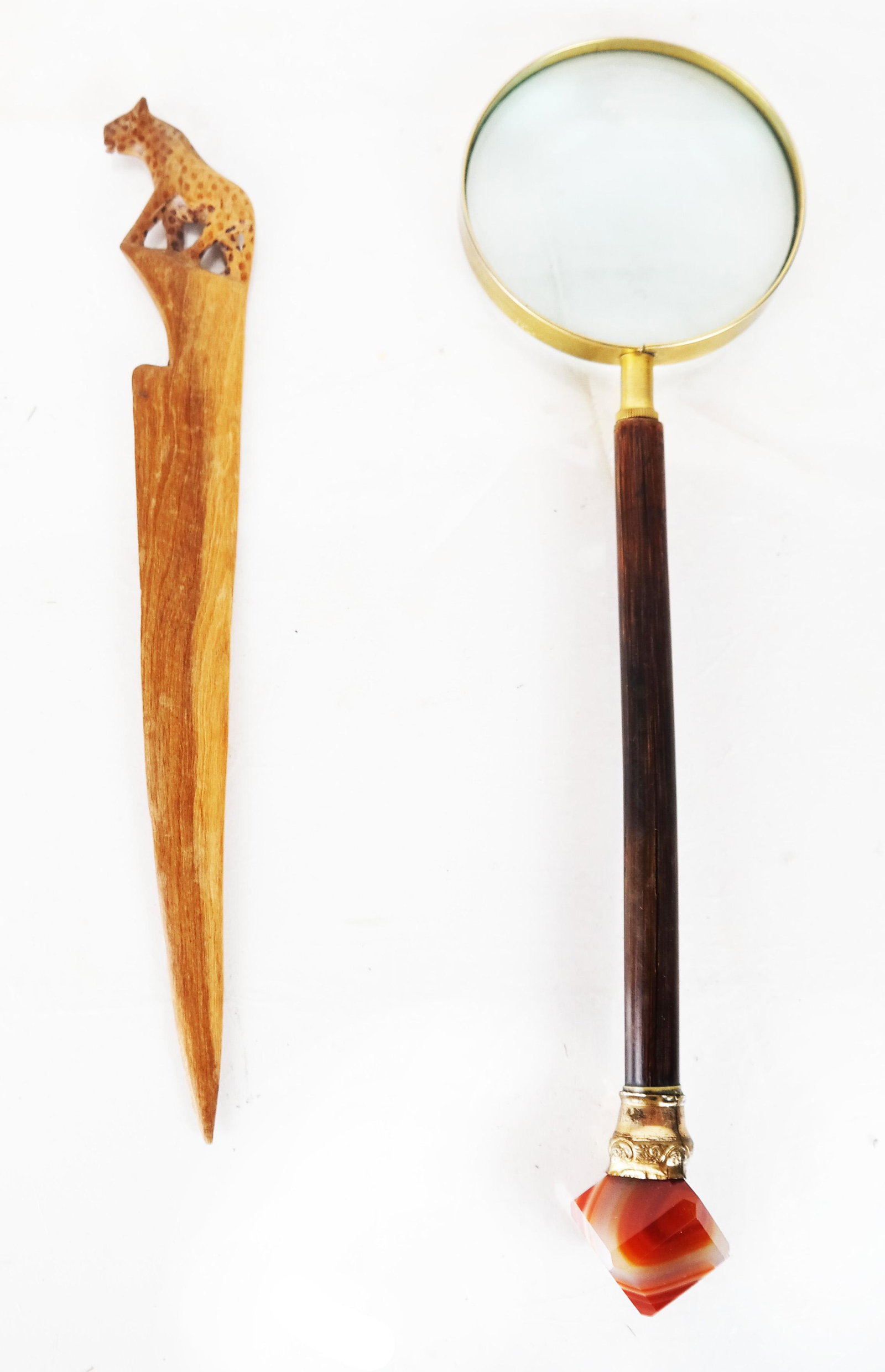 Magnifying Glass & Teak Letter Opener: Magnifying glass with brass fittings, bamboo handle and cube-form polished agate pommel, together with a carved teak letter opener with leopard pommel. [Glass: 13" L; letter opener: 10 3/4" L]. Bamboo