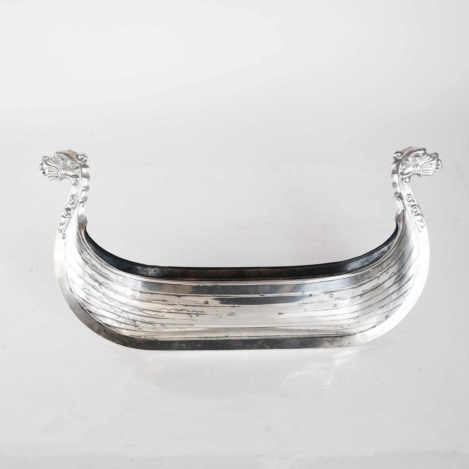 H. Aase, Norway Silver Plate Viking Ship: Silver plate Viking ship sculpture, stamped "H.AASE / Norway". [7" H x 14" W x 4" D].