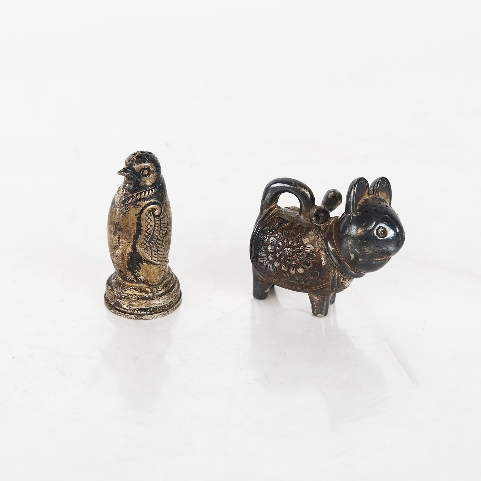Two Silver Sculptures: Foo Dog and Penguin: Silver penguin and foo dog sculptures. 1.4 ozt.