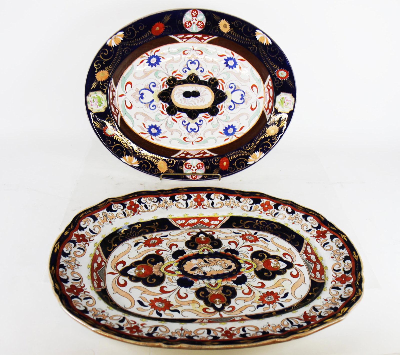 Two English Ironstone Chargers: Two English ironstone chargers. [16 1/2" W x 22" D; 15" W x 19" D]. Both in good condition.