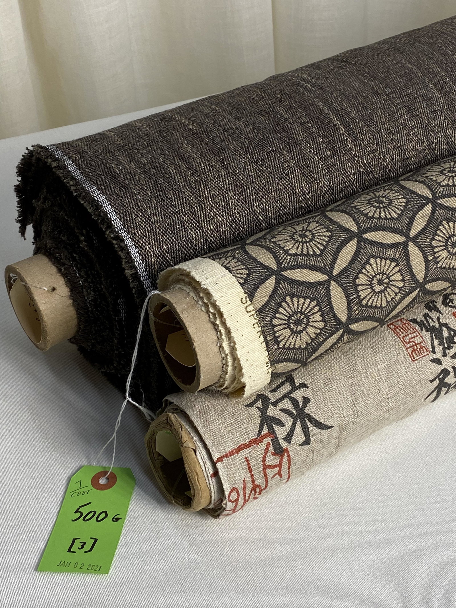 Colefax & Fowler and Tino Zervudachi Fabrics: 1) 14 1/4 yards of Colefax & Fowler's subtle diamond "Arundel", #F4226/10, in heathered charcoal and tans in a viscose, linen, poly and cotton blend, 56" wide for upholstery. 2) 3 3/4 yards of "Circle