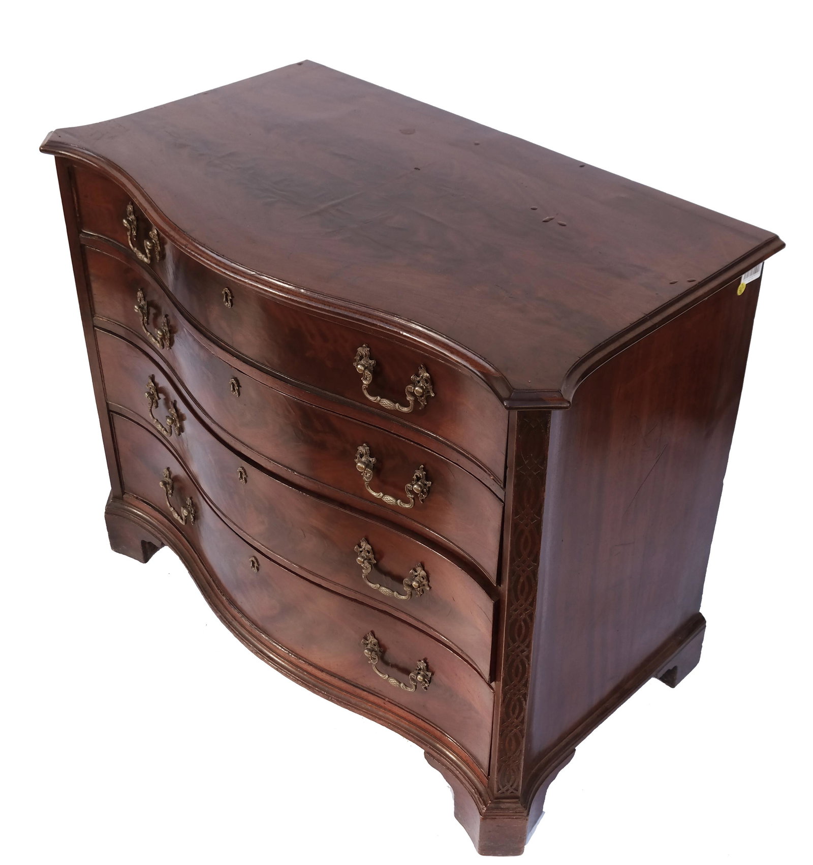 George III Mahogany Gentleman: George III serpentine mahogany gentlemen's dressing chest, fourth quarter 18th century, flanked by blind fret decorated stiles, the upper drawers with a well fitted interior. Provenance: Bonhams, Los 