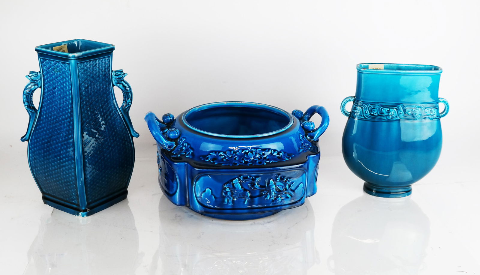 Theodore Deck & Longwy Blue Faience Ceramics (3): Two Theodore Deck faience "Persian Blue" vases, circa 1875, bearing impressed "TH Deck" marks, the first with dragon handles, the second of flattened Hu form with a band of scroll decoration at the ne