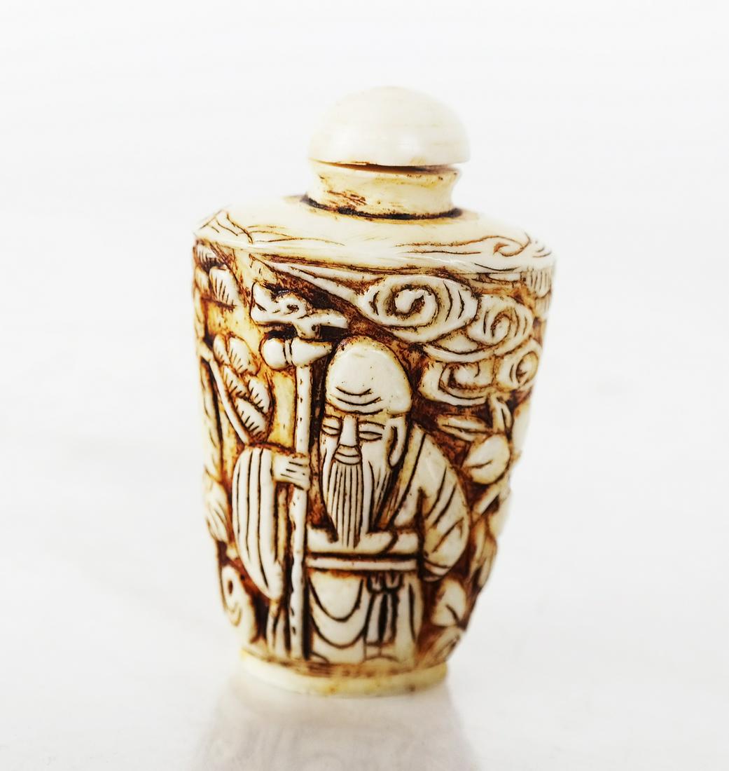 Chinese Carved Bone Snuff Bottle: Chinese bone snuff bottle, with relief carvings of an old bearded man and tigers. [2 3/4" H].