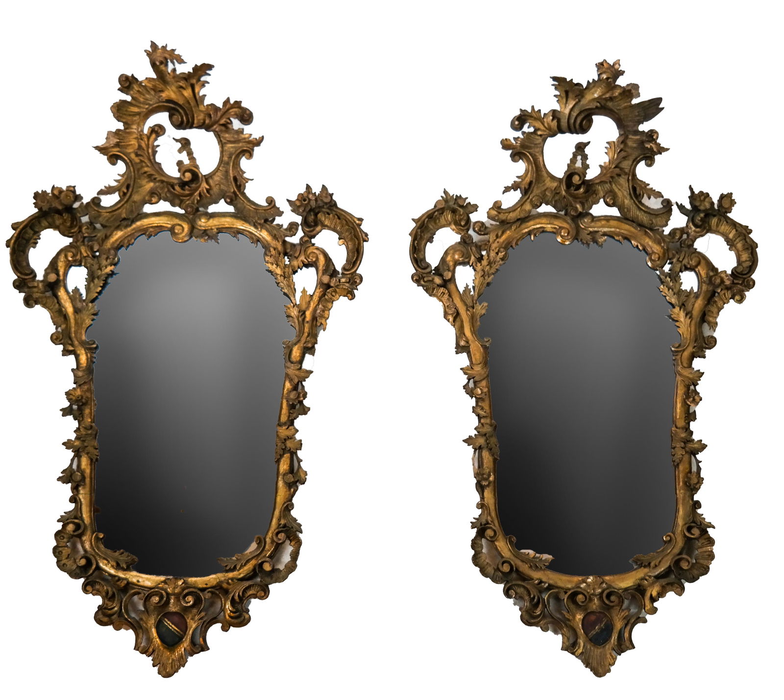 Pair of Antique Carved and Gilt Wood Mirrors: Pair of fine Italian Rococo period carved and gilt wood mirrors, made as an opposing pair, one facing left and other other facing right. Possibly Venetian, circa 1760. Mirror glass has been replaced.