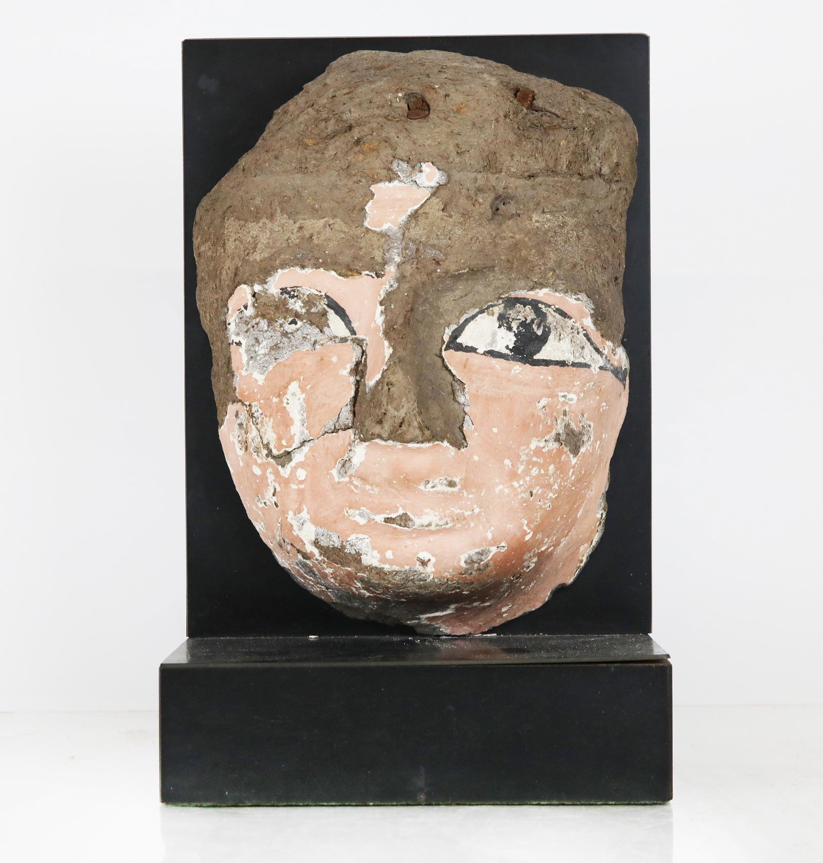 Ancient Egyptian Mummy Mask on Stand: Ancient Egyptian mummy mask, on a stand. Comes with Guarantee from Aladdin House, Ltd., NYC (see photo). [Mask: 10" H x 7" W; 11 1/2" H x 7 1/2" W x 4 1/2" D (base)]. Mask sold "as-is".