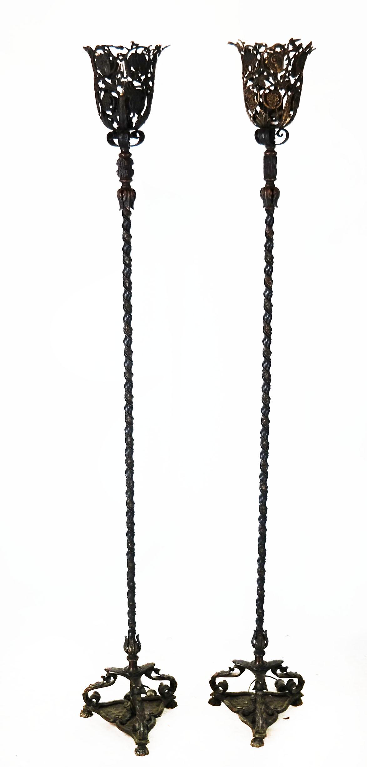 Pair of Wrought Iron and Bronze Torchieres: Pair of American ornate wrought iron and bronze torchieres on tripodal base. [66 1/2" H x 11" W x 11" D].