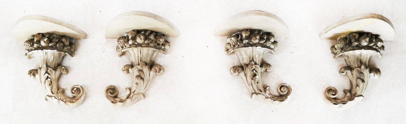 Set of Four Cornucopia Appliques: Set of four composite cornucopia bracket-form wall appliques. [13" H x 12" W x 9" D]. Some repairs; losses.