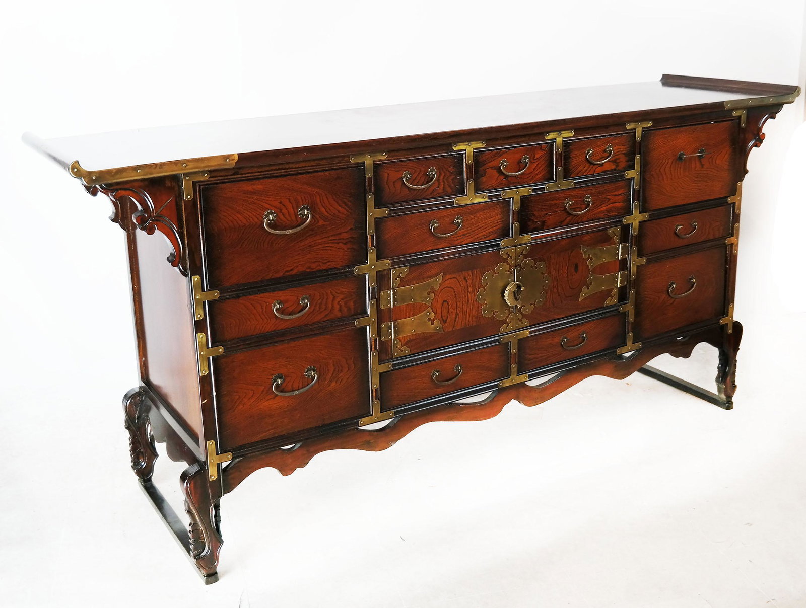 Korean Rosewood Sideboard: Korean rosewood sideboard, with 13 doors flanking a central 2-door cabinet, with brass mounts. [31 1/4" H x 66 1/4" W x 17 1/2" D].